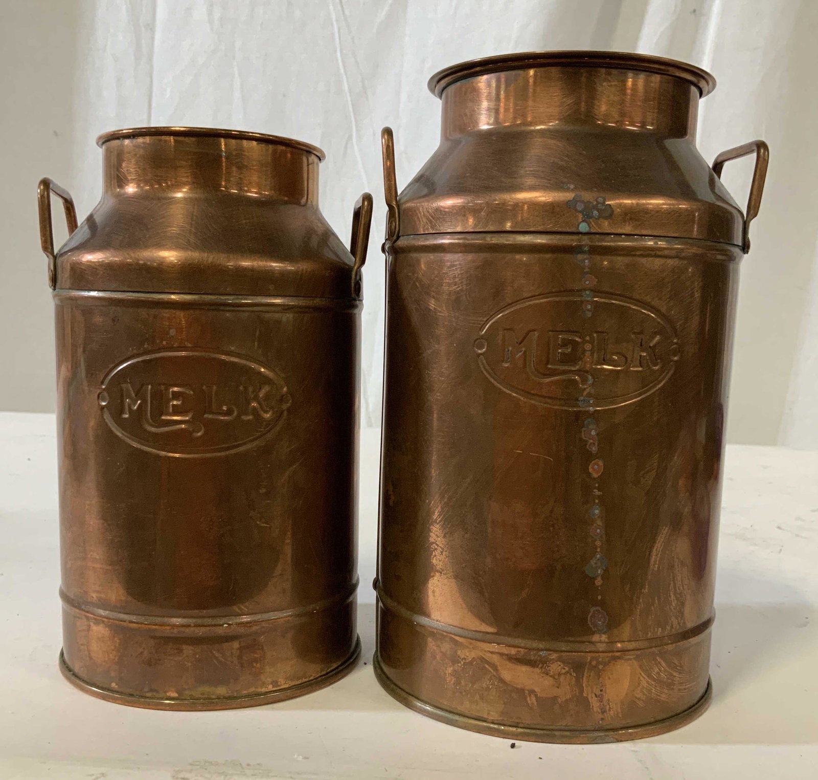 Lot 2 Copper Milk Jugs Canisters: Each labeled MELK, taller measures ht 9 inches, copper kitchen ware, vintage copper collectibles