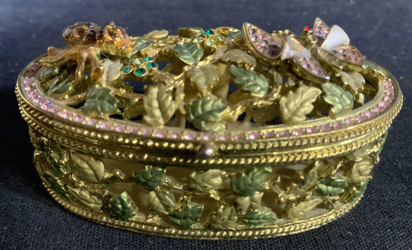 Bejeweled costume Gold Toned Pill Box: Trinket box, lidded, Crystal encrusted jewel toned insets to filigreed gold tone design base, measures 1 inch ht, 3 by 2 inches, dresser top accessory, pill box, keepsake box, decorative accessories