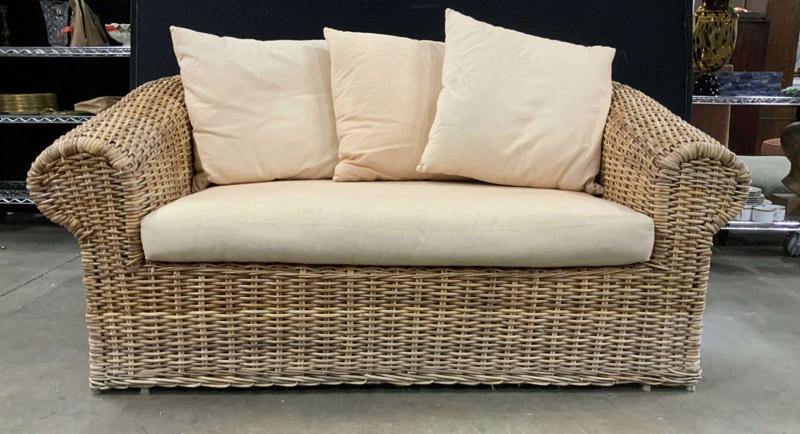 KREISS Wicker Sofa Loose Cushions: KREISS, bygone luxury designer showroom in New York City famed D and D Building, large Framed Wicker sofa, one of a pair ,match in separate lot. wide scrolled arms and back, frame to floor, loose seat