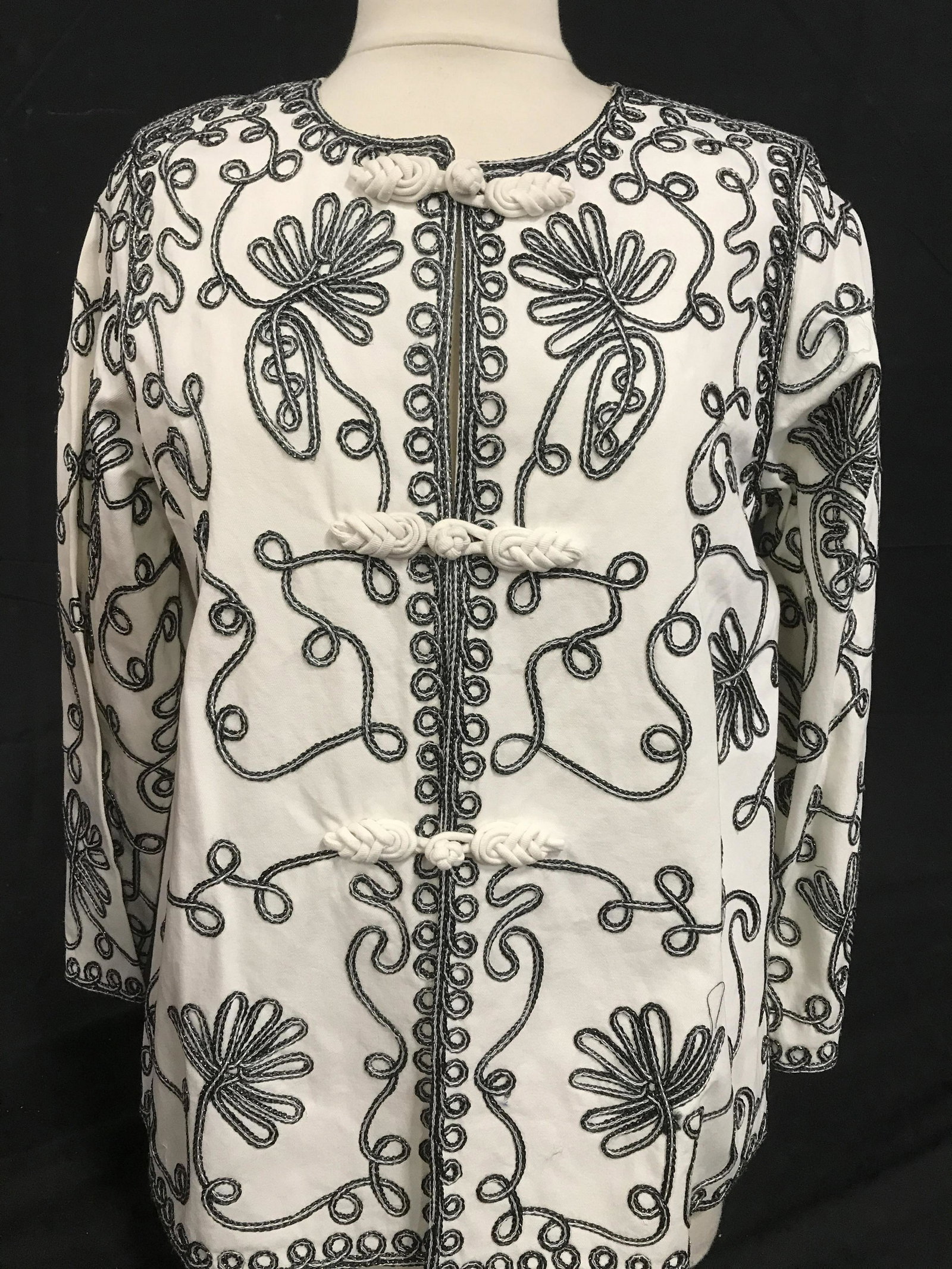 Lot 3 Victoria Costa Occasion Cocktail Jackets, M: Both black & white with embellished textile loop and floral design. Both 95%-100% Cotton. Both Medium. Both app 25 in. long Wide strait bead crew collar with black tropical floral design on white back
