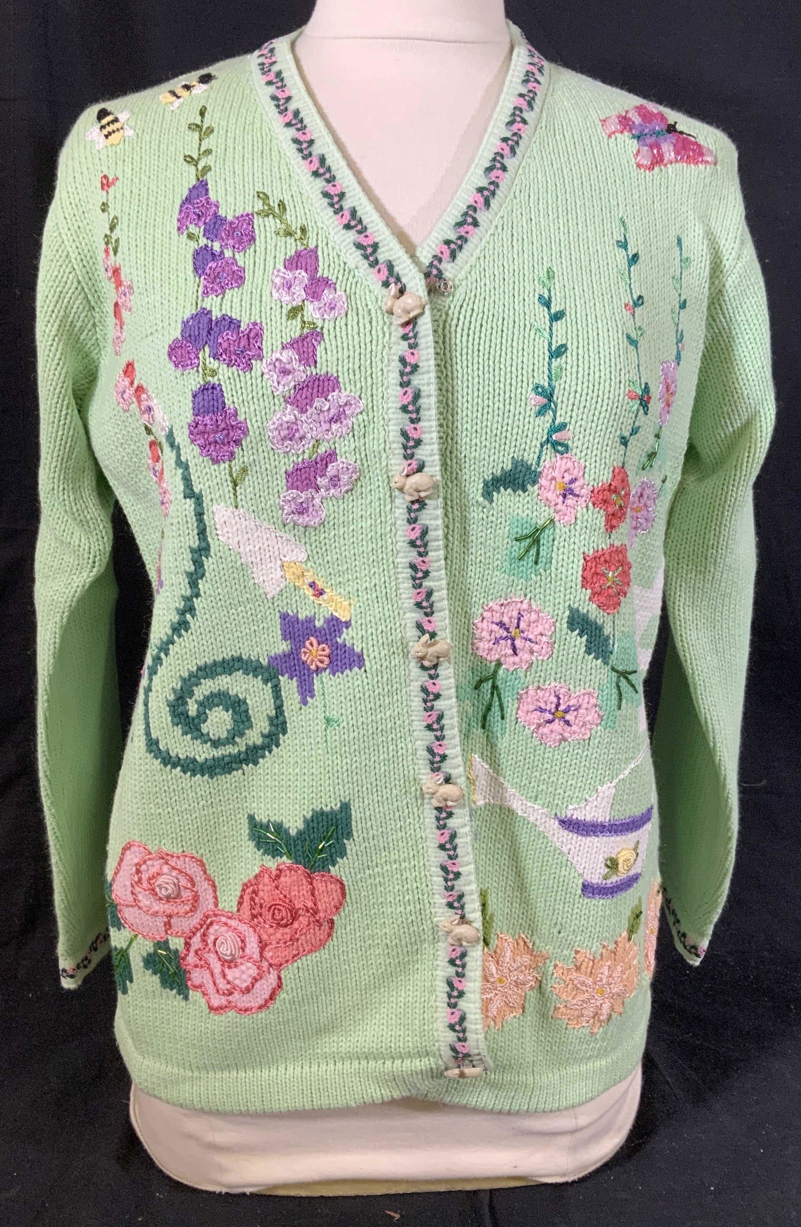 Hand Kit Story Book Knits Button up Sweater: Vibrant design on pale green back ground, floral design, fits size small, rabbit form buttons one side, lime green on reverse, hand knit sweater, vintage fashion