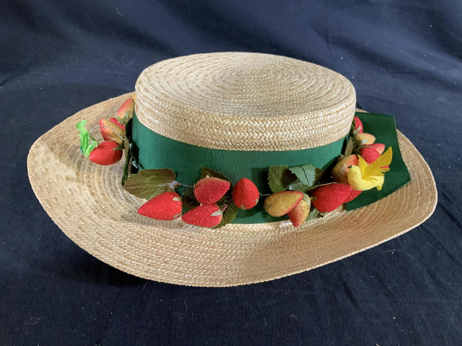 GOBBE NEW YORK millinery Luxury Hat: Wide brimmed straw hat adorned with faux strawberries, and green ribbon,and mini birds and bees, label for GOBBE New York, luxury vintage fashion accessory, hat, bonnet, spring fashion, inside diamete