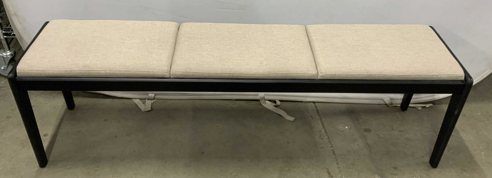 Contemporary Upholstered Wood Bench: Good condition , soft gray beige upholstery, black smooth wood frame, upholstered bench, seating, measures ht 19 inches 61 length app 13 inches depth, extra seating, under window bench, end of bed ben