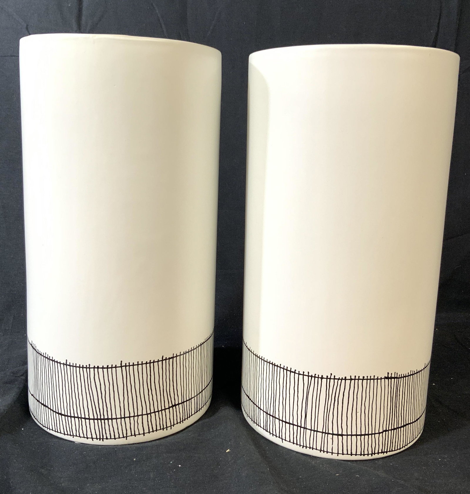 Pair Contemporary Cylindrical Ceramic Vases: Matte white pottery vases with pin striping black lines design around lower portion, contemporary vases, decorative accessories, table ware, vessels. each measures ht 11.5 inches, diameter 6 inches