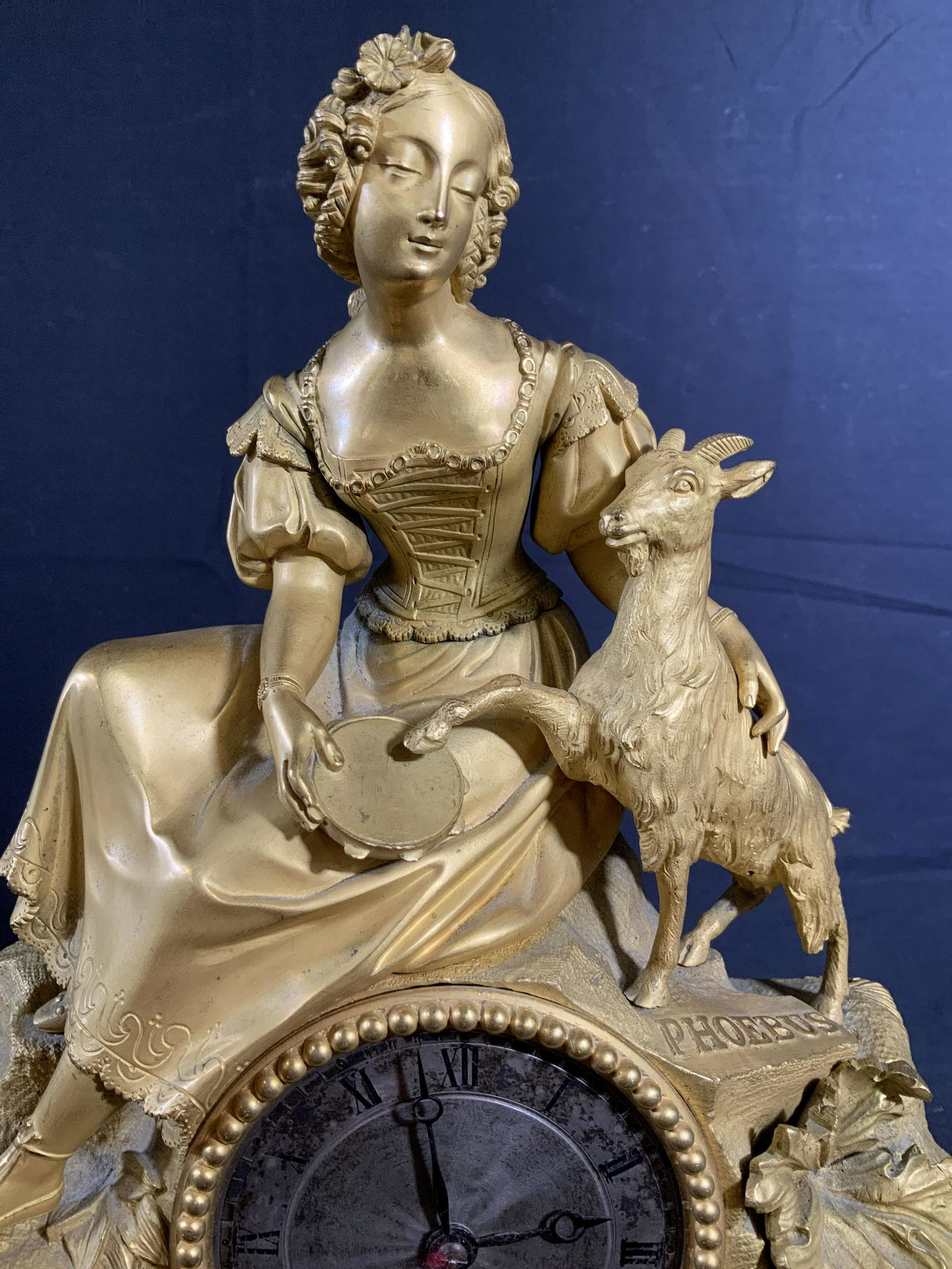 Antique French Dore Bronze Mantle Clock: Antique French Bronze Clock, French antique 19th century clock, inscribed PHOEBUs at Top , elaborately detailed base with s scrolls, C scrolls, flowers and vines in relief, top has seated female figur