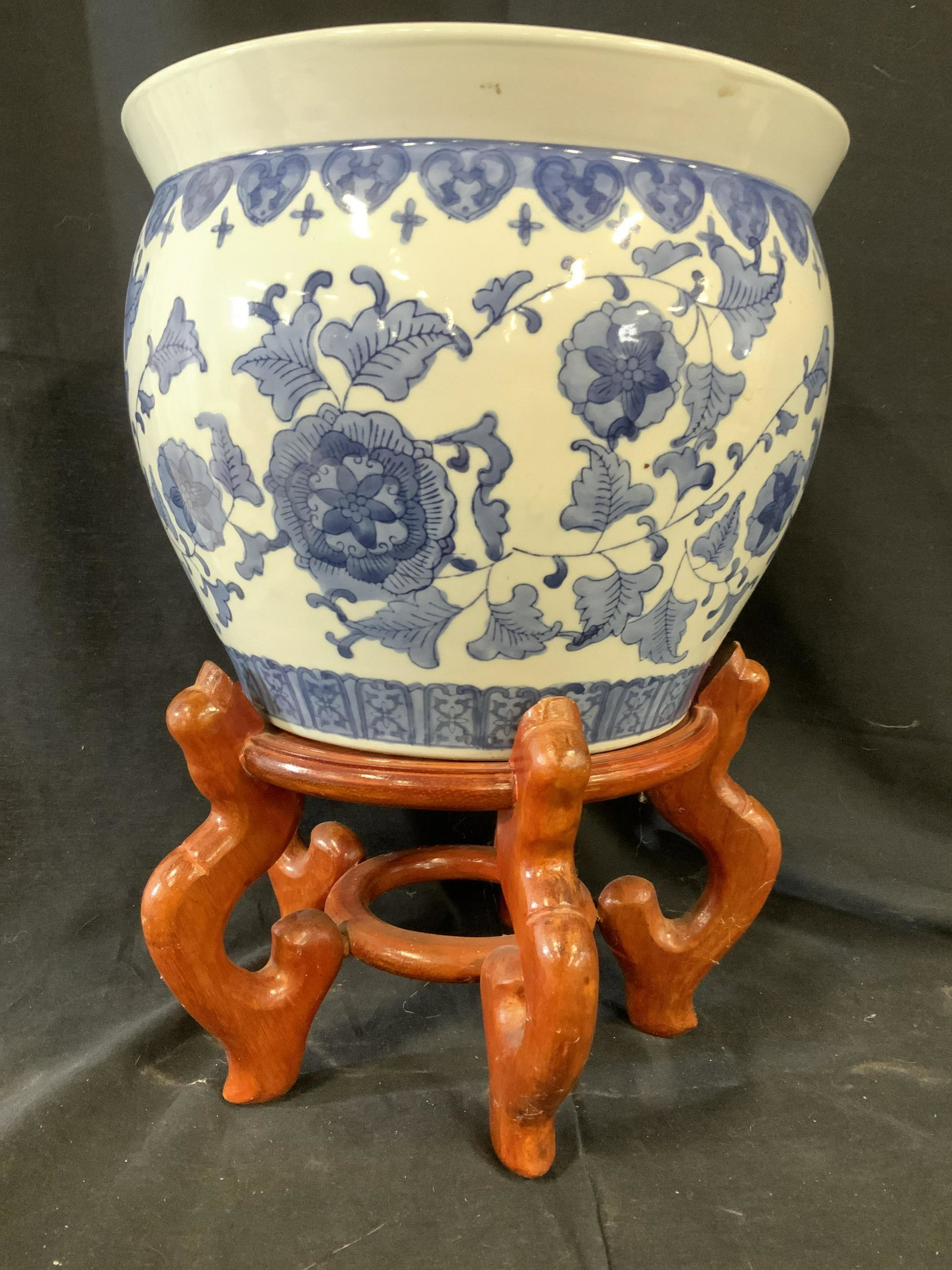Chinese Blue White Ceramic Planter on Stand: Signed underside in Asian characters, also on underide reads made in China, blue and white ceramic porcelain planter, vessel on wood stand, together ht app 17 inches, diameter app 12 inches, chinoiser