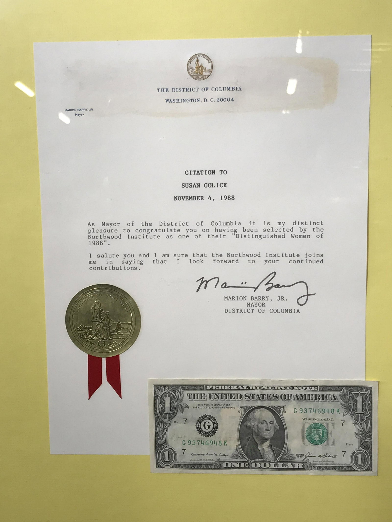 Signed Mayor Marion Barry Jr. Collectible Ephemera: Signed Collectible Ephemera consisting of a Mayoral Letter from Mayor Barry Jr. a list of ‘Distinguished Women of 1988’ and a dollar bill, the mayoral letter reads across the top ‘The District o