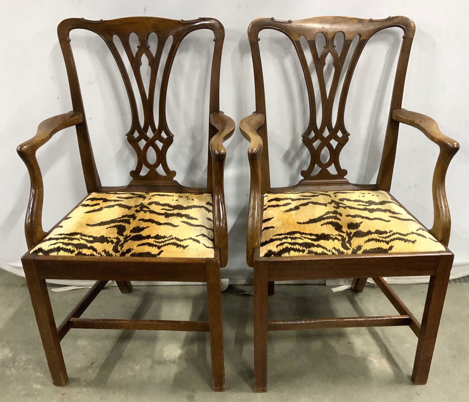 Pr Antique WARINGS English Chippendale Chairs: Antique chippendale arm chairs each upholstered in Clarens House Silk Velvet Le Tigre Upholstery, carved slat backs, shaped arms and box stretchers, good condition, each has plaque underside which rea