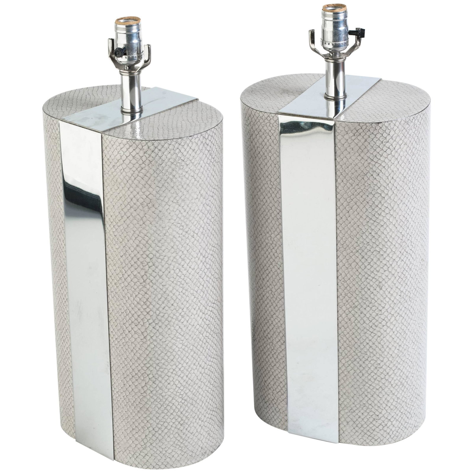 Pair Vintage Faux Snake Skin Chrome Lamps: Pair Mod style cylindrical lamps with faux snake skin and polished chrome exterior, , circa 1970’s lamps, table lamps, lighting, each measures height to top of socket 23 inches, w 9.5 inches, d 6.75