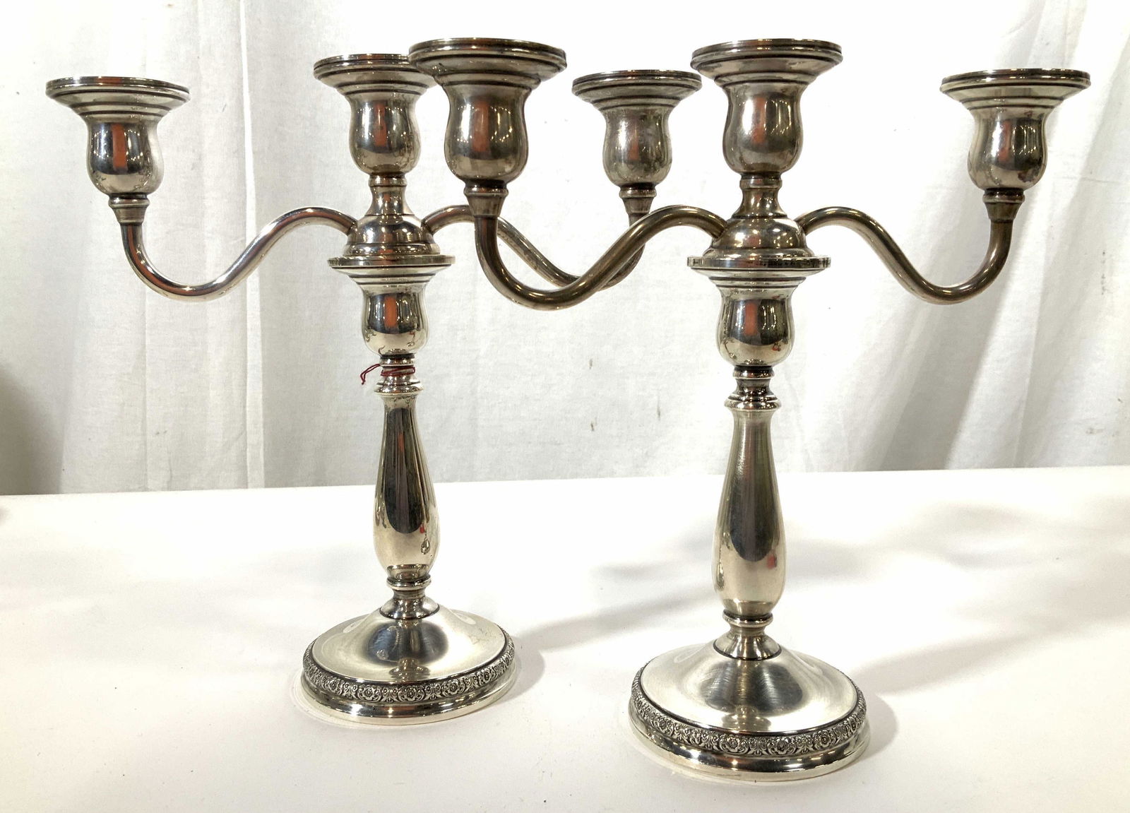 Pair PRELUDE Sterling Silver 3 Arm Candelabras: Pair of sterling silver candelabras, each with three arms, center removable to form pair of single candle holder candles sticks, each measures ht app 10.5 inches width 10 inches, base diameter 4 inche