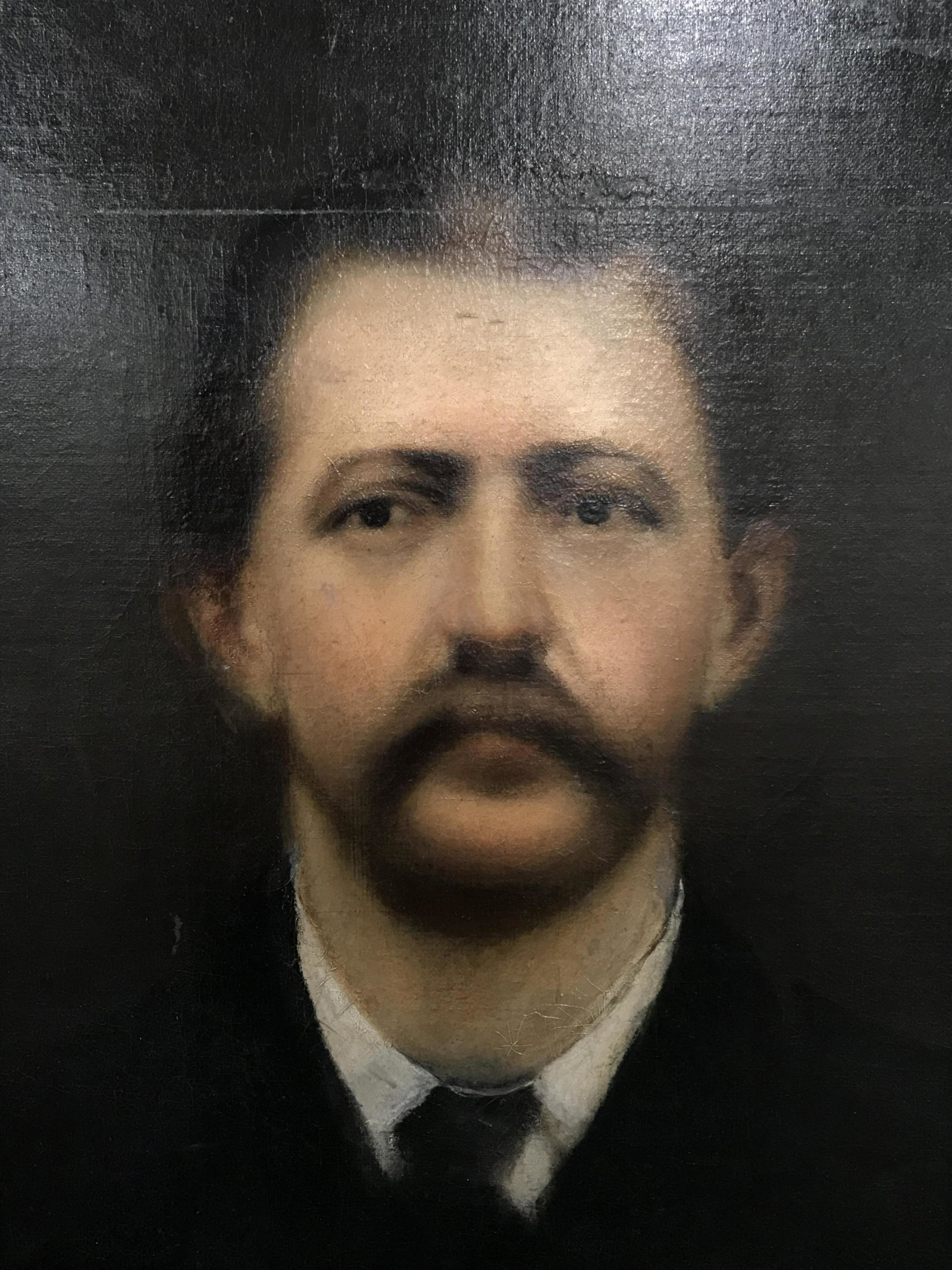 Oil on Canvas Portrait of a Man: Oil on canvas portrait of a man, no apparent signature, subject portrait of a man in suit and tie with beard, chiaroscuro style portraiture, some cracks to painting from age, cut in canvas that has be