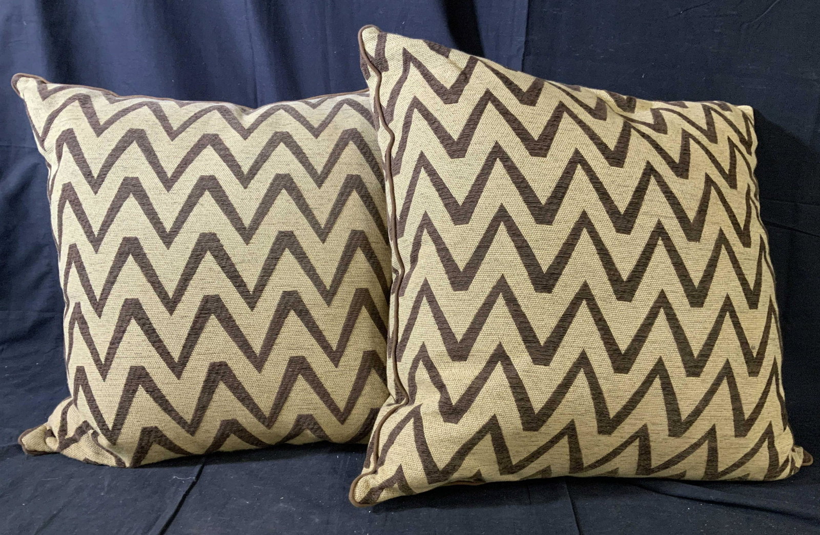 Pair Oversized Tribal Style Toss Pillows: Pair of down filled tribal style throw pillows, wheat toned linen ground with velvet feel chocolate brown threadwork chevron pattern, coordinating piping trim, very good condition, property of Greenwi