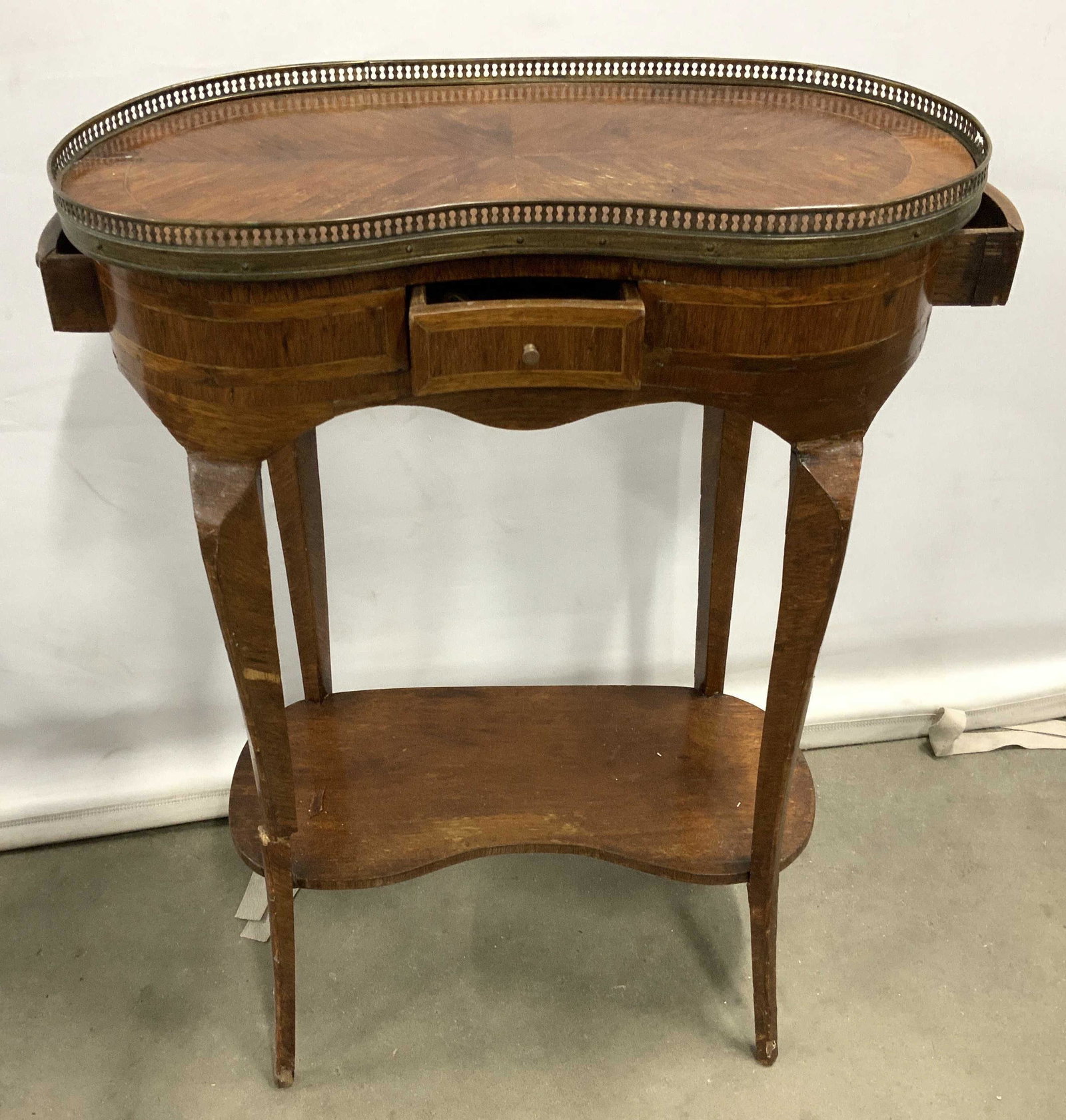 Antique Kidney Shaped Side Table: Marquetry parquetry inlaid veneered table, brass gallery, home furnishings, vanity table, side table, end table, entry way furniture, lower shelf, and brass feet measures ht 29 inches by 21 inches by 