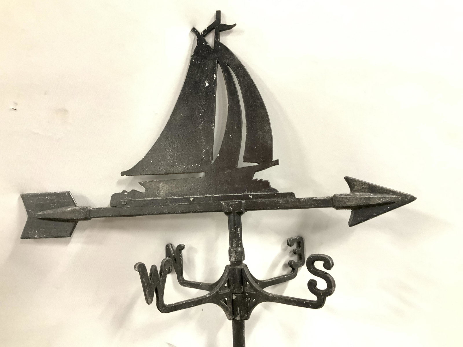 Vintage Poss Antique Black Metal Weather Vane: Sailing vessel with open masts rests on arrow, north south east west letters on directional spokes under arrow, long metal pole for roof attachment or posting in ground, collectible weather vane, mari