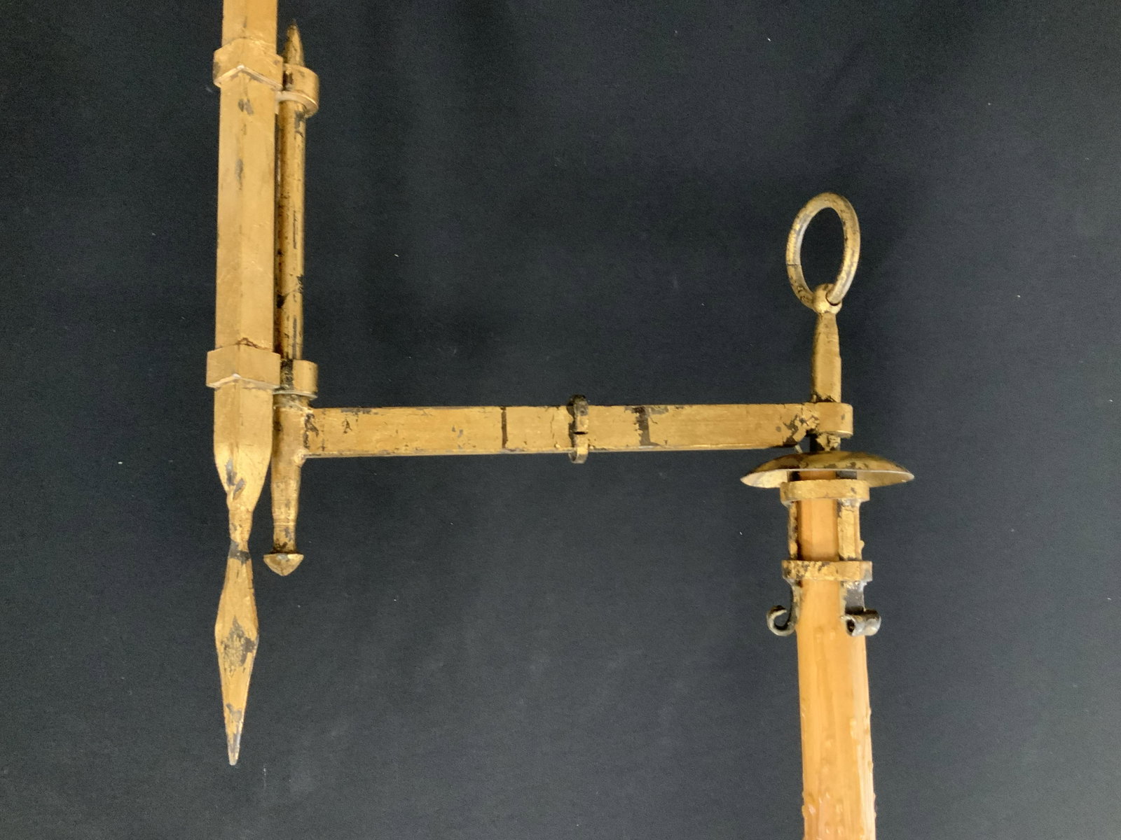 Gold Leafed Iron Floor Lamp: Floor lamp is gilded metal, four splayed feet, arrow head finial, swing arm rotates and adjusts has hanging metal ring detail and candle holder framed stand, piece measure ht to finial 12 inches, widt