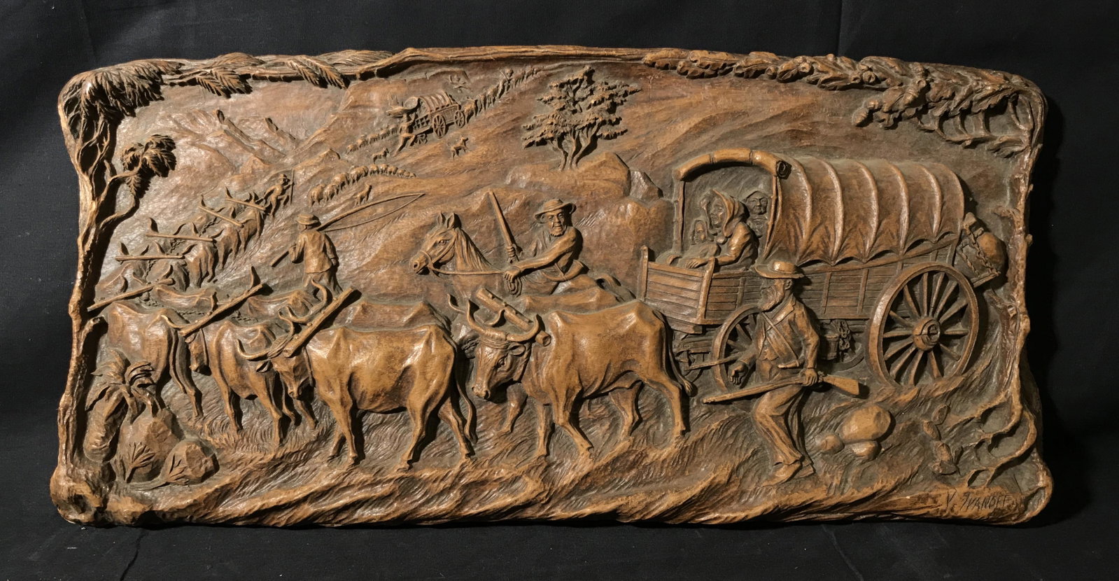 Signed Wood Carving Victor Ivanoff: Signed wood carving, signature in the lower right corner reads V. Ivanoff, signature referring to the artist Victor Ivanoff, subject wood carving depicting wagons and cattle following a path up a moun