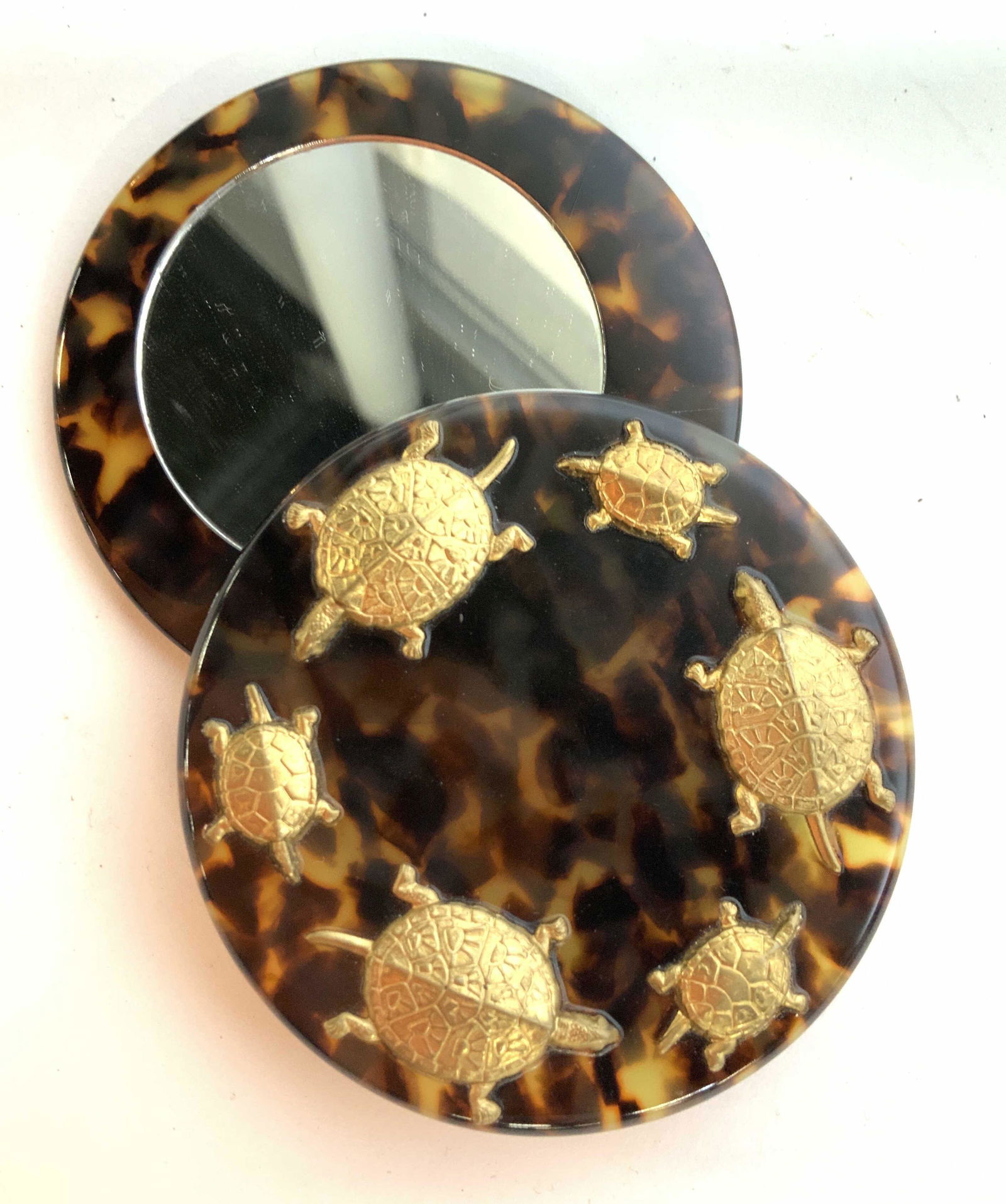 Faux Tortoise Shall Compaq with Brass Turtle: Design swing open faux tortoise shell compact mirror, diameter closed 3 inches, with ring of gold toned turtles design, turtles in relief, vintage dresser top accessory, collectible, decorative arts