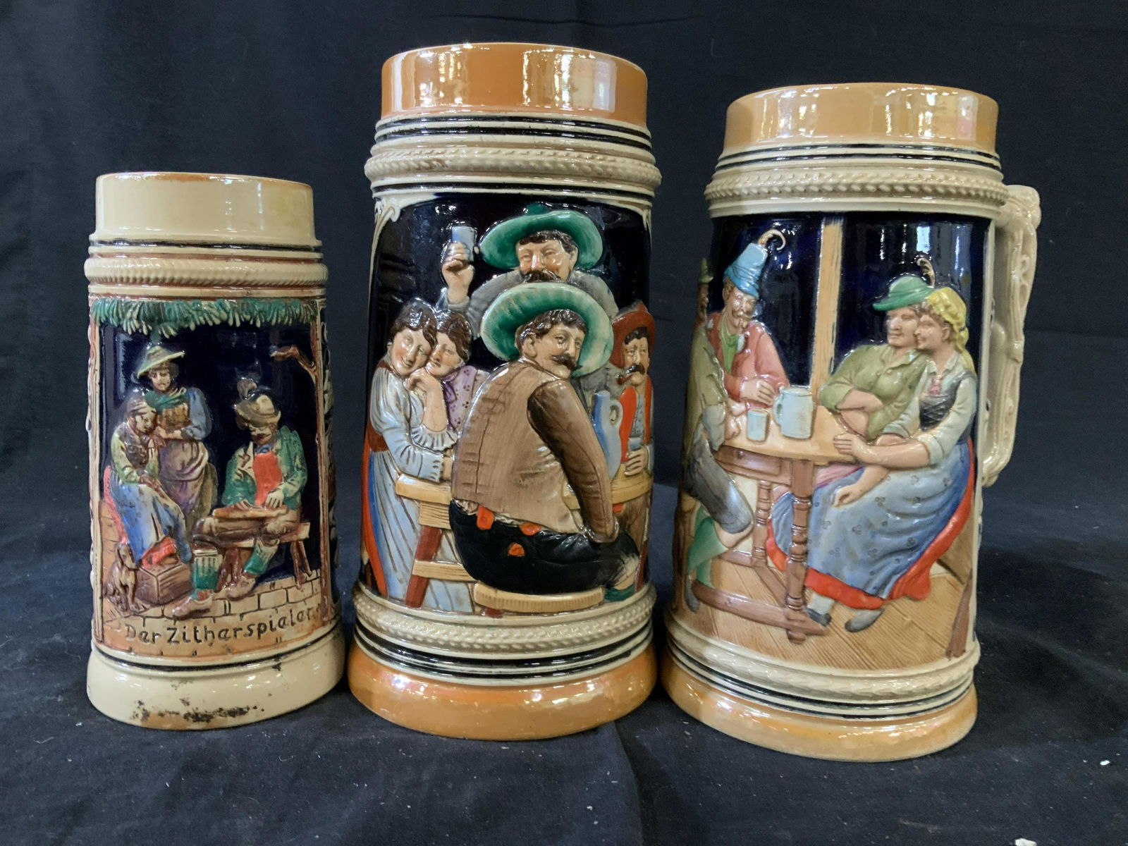 Group3 German Porcelain Beer Steins: Porcelain ceramic steins, german tankards, mugs, with Figurals in pub settings, tallest measures 8.5 inches, collectible bar ware,