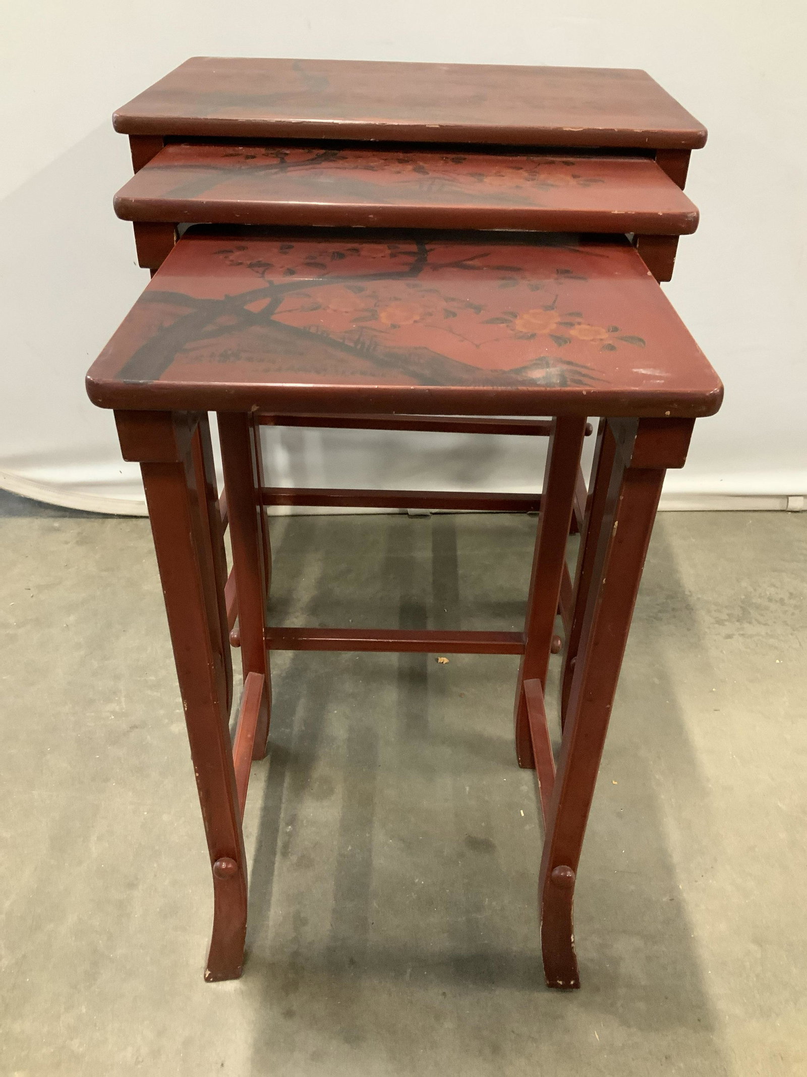 Set 3 Asian Lacquered Nesting Tables: Red lacquered wood each with floral design, set of three, tallest measures ht 27 inches, top 22 by 14 inches, Asian decorative arts, orientalism, orientalia