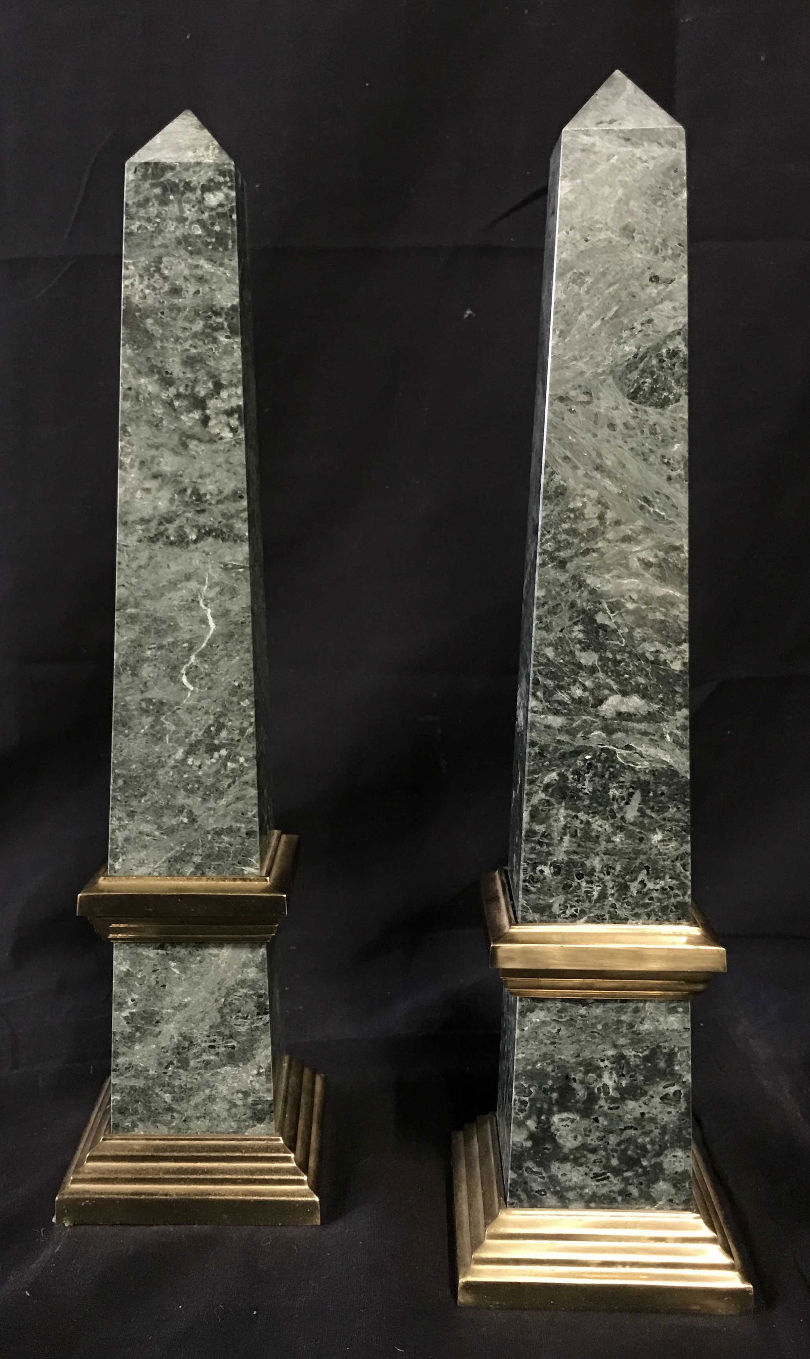 Pair of Twin Green Marble Obelisks: Pair of twin green marble obelisks, solid pillars with gold metal bases and decor, one pillar has a black velvet bottom while the other shows how the base is bolted into the stone, measures 14.5 at hi