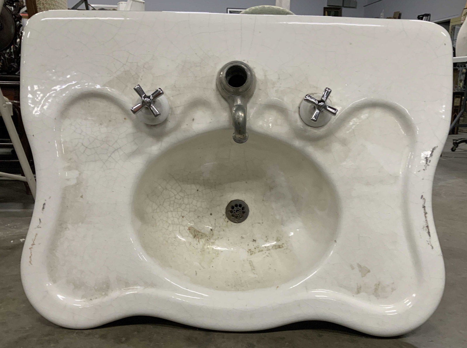 Antique Porcelain Sink on Legs: Antique heavy weight porcelain sink, circa 1907, needs cleaning,sink alone measures app 34 by 25 inches ht of porcelain 8 inches, has two shaped front legs each measures 25 inches, one has iron attach