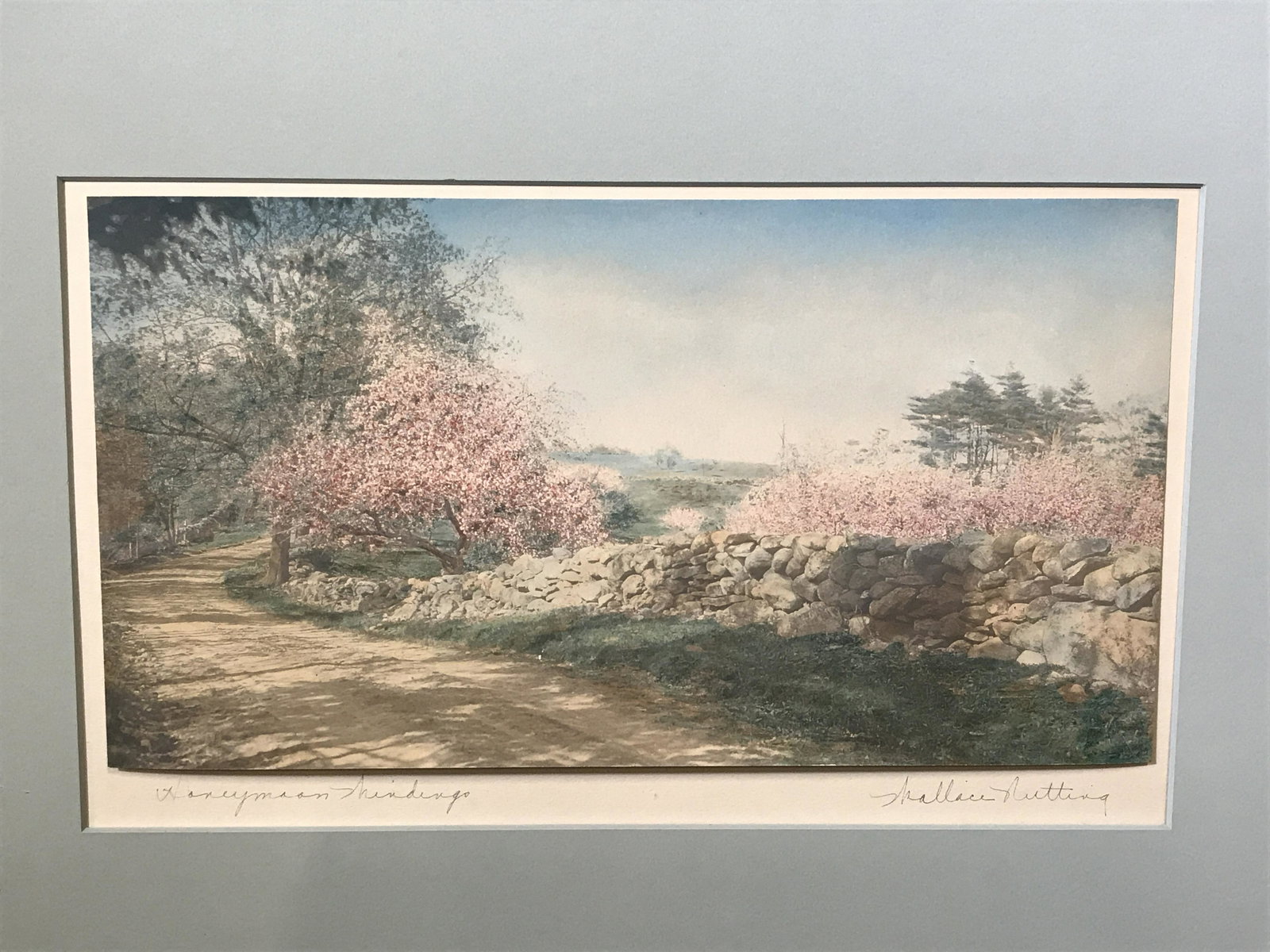 Signed Print of a Landscape, Wallace Nutting: Signed print of a landscape, signature in the lower right corner, appears to read Wallace Nutting, text in the lower left corner illegible, scene depicts a dirt road trees a rock wall and rolling hill