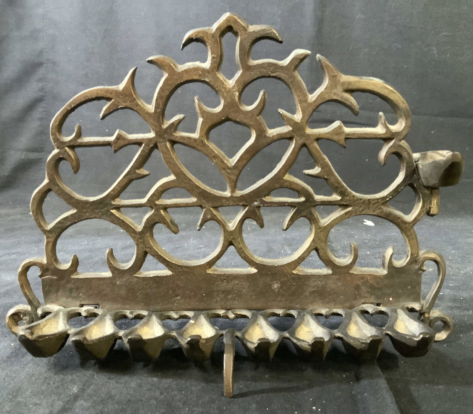 Scrolled Metal Menorah, Judaica, Hebraica: Israeli decorative arts and crafts, Jewish ceremonial tableware, menorah measures ht 6.5 inches length 9.5 inches