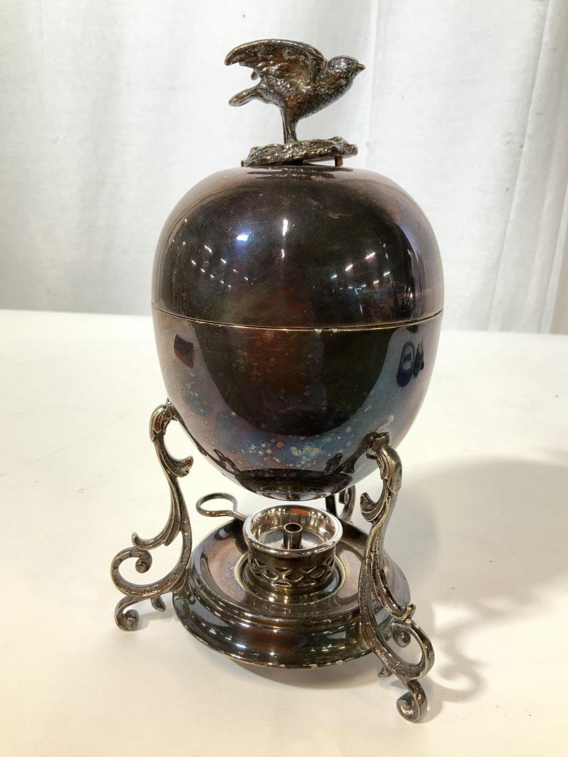 Silver Plate Bird and Egg Form Vessel: Multiple trade marks on underside lidded oval egg form on thee legged scrolled base, lid lifts to open vessel, bird form finial, and warmer tray, table ware, decorative arts, silver plate vessel, meas