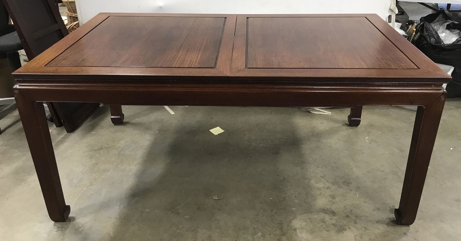 Vintage Asian Style Wooden Dining Table: The table is extendable, and include several extensions to increase the length of the table. The piece features horse hoof styled legs, and carved detailing on the table top. The piece measures approx