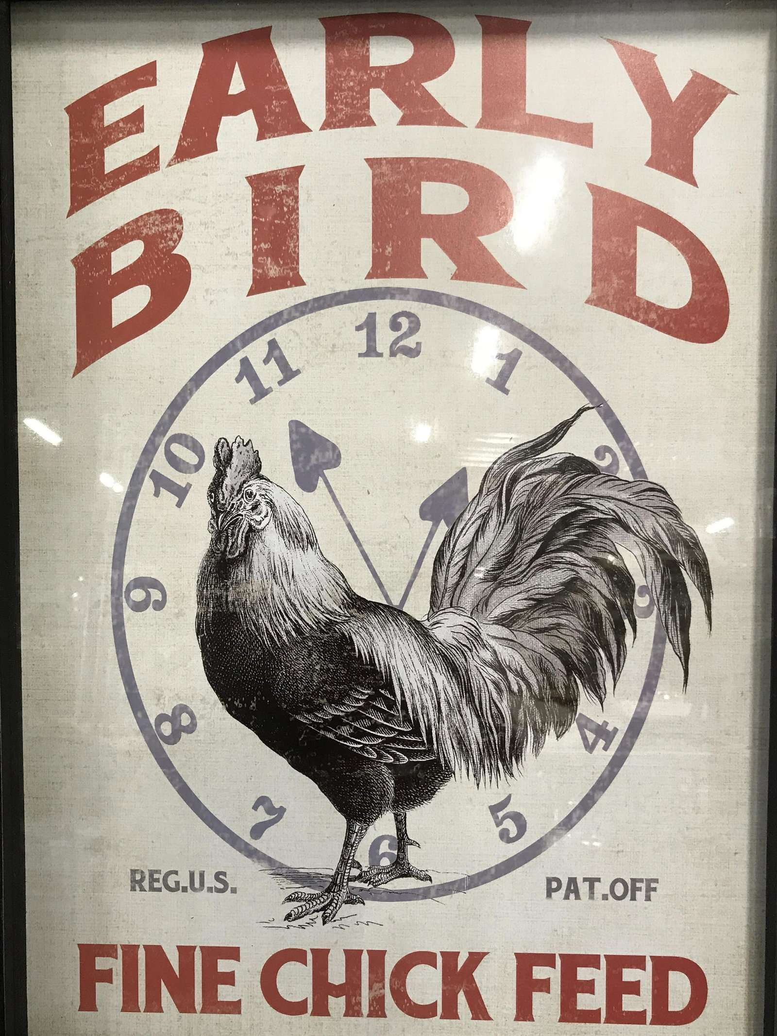 Framed Fine Chick Feed Advertisement New in Box: Framed Advertisement, ad displays text and the head of a black and white chicken on a white and blue clock face, text on top center section reads ‘Early Bird’, text in lower section reads ‘Reg. 
