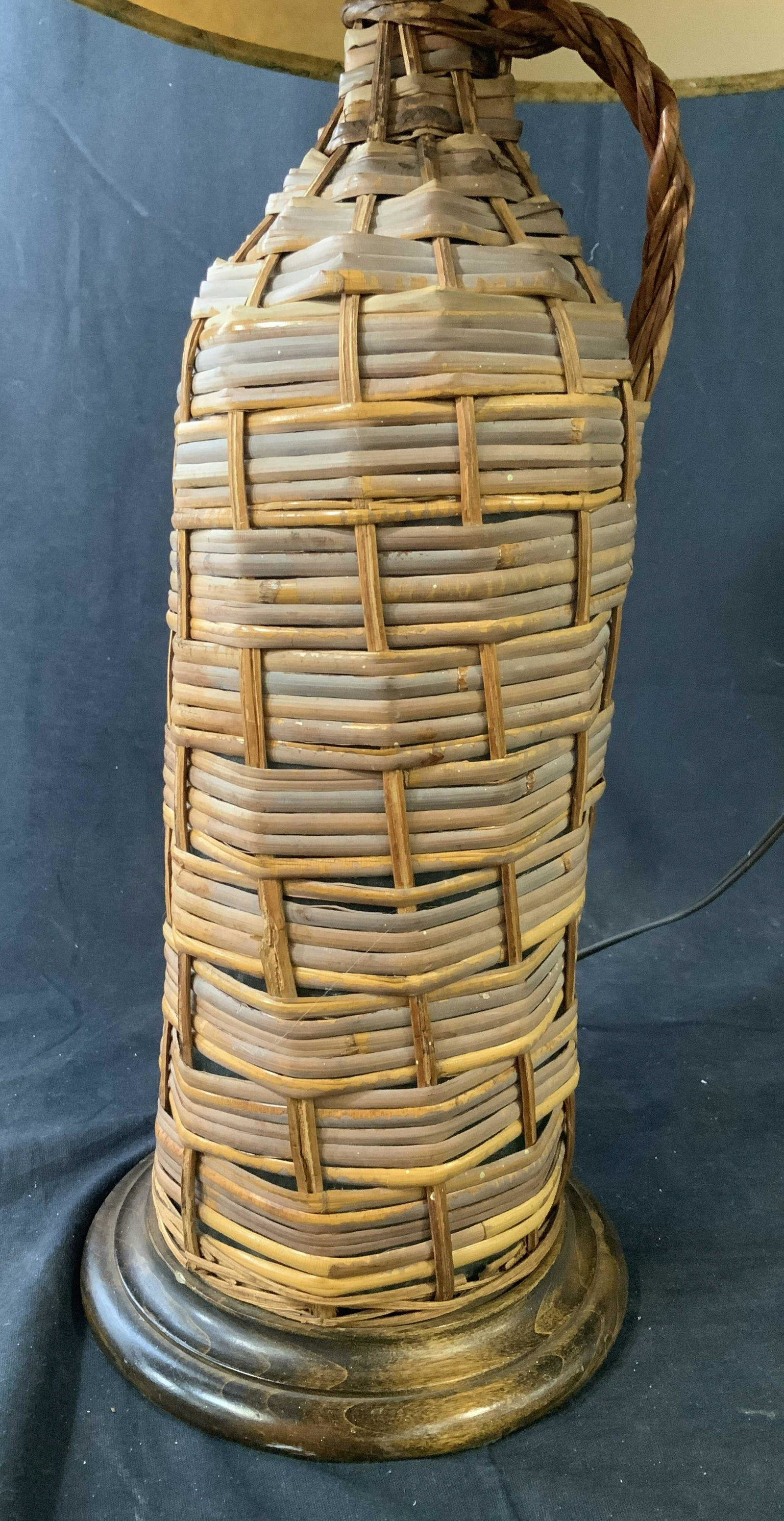 Vintage Bittle in a Basket Lamp: Woven rattan around glass bottle on wood stand as vase, shade is map graphics, measures ht to finial 28 inches, country decor, country lighting, cabin lighting style