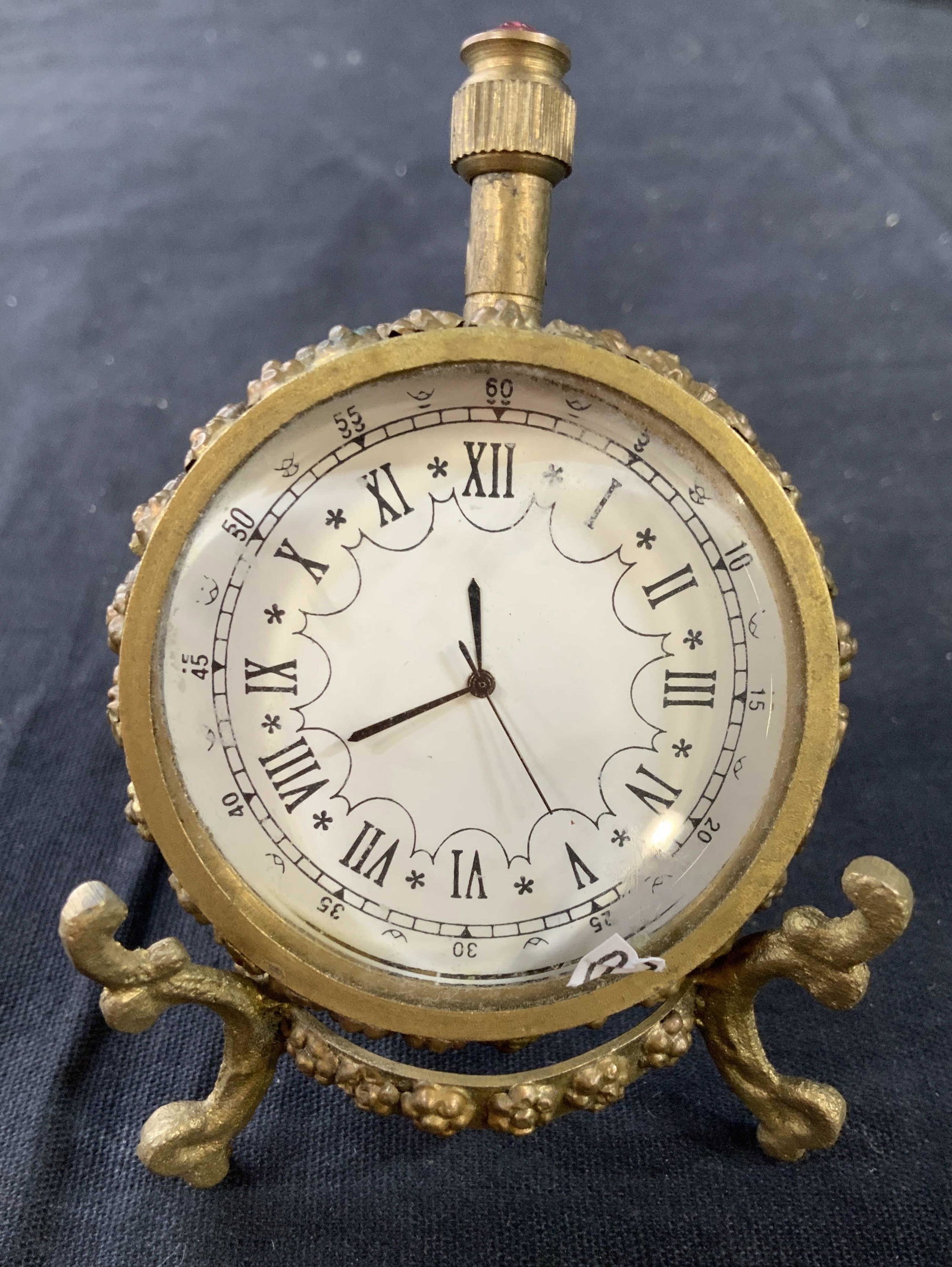 Paris 1873 Gold Toned Clock w Stand: Gold toned metal clock with articulated coordinating metal stand, clock , stop watch shape has pink rhinestone accent, etched into back reads Paris 1873, on stand measures ht app 4 inches, desk top ac