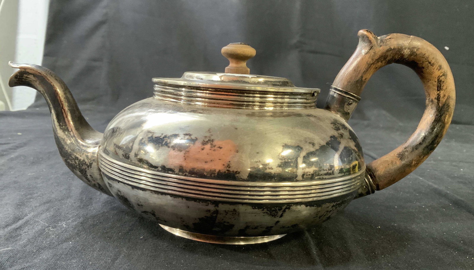 Lindman MK 1836 Silver Tea Pot: Wood handle wood knob, silver toned tea pit, silver plate possibly silver some trademarks underside illegible some signatures include Lindman, 1836, , MK, 84, antique table ware, measures ht 5 inches,