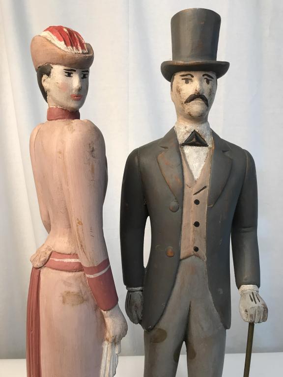 Pair NYC Haberdashery Folk Art Sculptures: Possibly antique Edwardian haberdashery Display folk art figurines, originally from a New York City haberdashery of men and womenÂ’s elegant attire. Hand-Carved and painted wood figures of gentlema