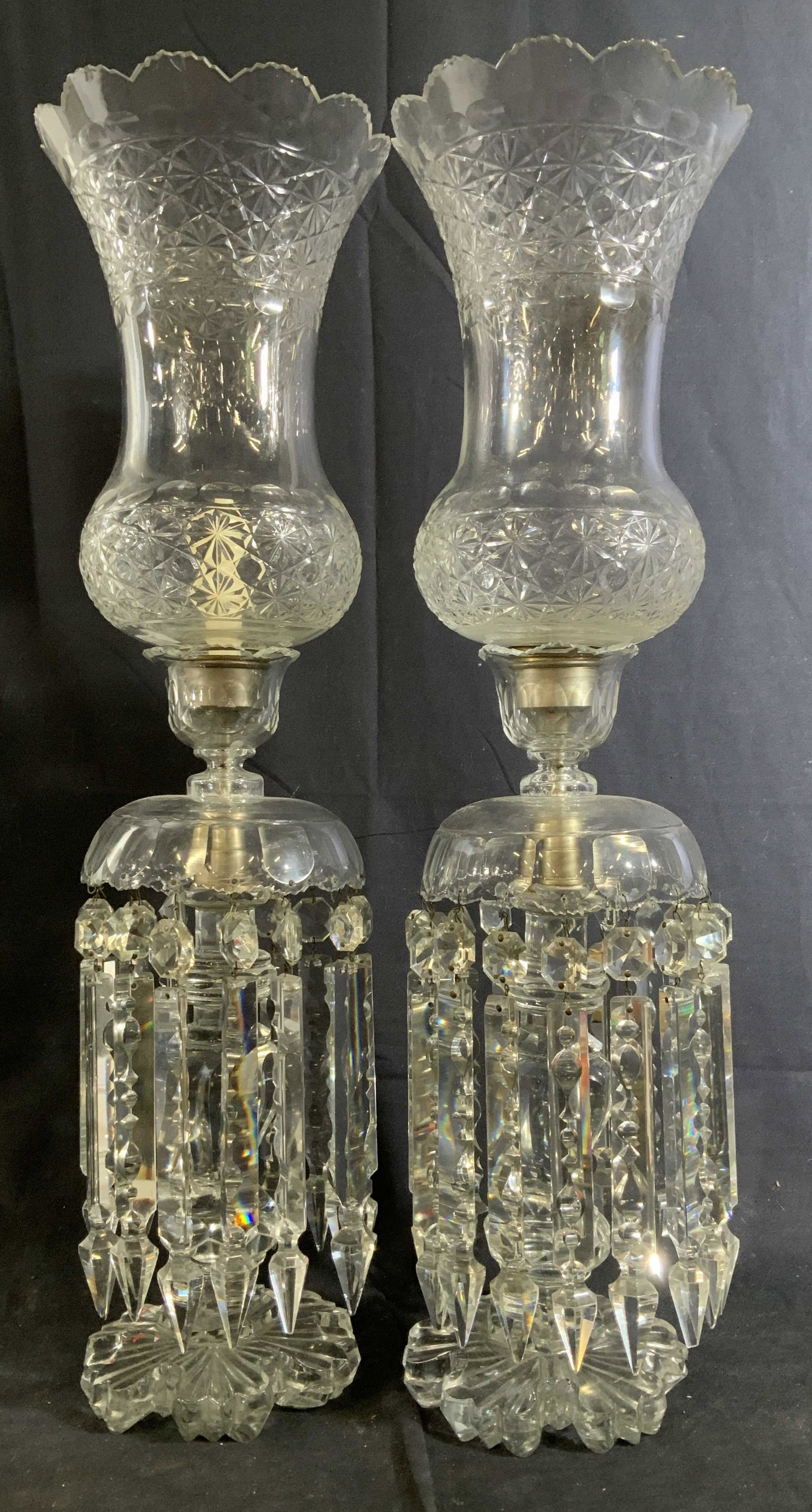 Pair Antique Russian Crystal Hurrican Lamps: Candle lights, candle sticks, candelabras, hurricanes, ornate cut Crystal statement pieces, each has thick cut glass circular ribbed base , with hand crafted center stalks in geometric patterns, wide 