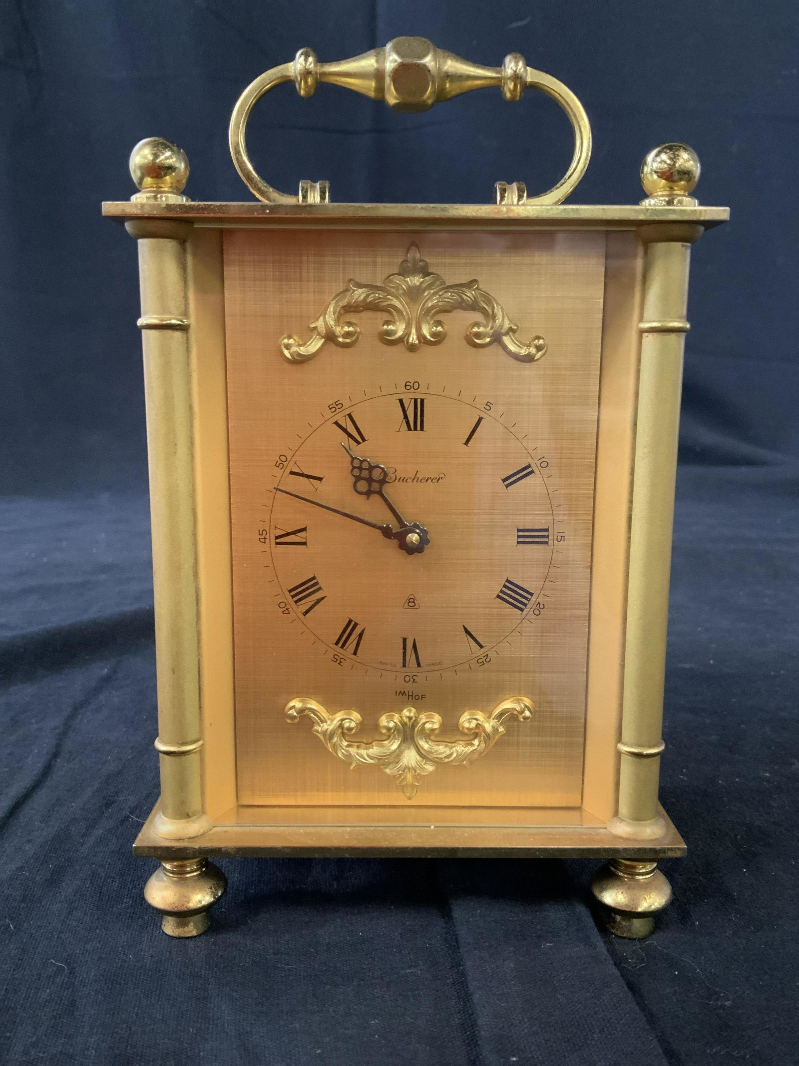 BUCHERER Gold Toned Footed Carriage Clock: Marked underside for Swiss, 7 384, also underside etched reads Buny R1463, gold toned clock face reads Bucherer, , 8 in a triangle, and IMHOF, Vintage Swiss Carriage Clock, collectible Bucherer, open