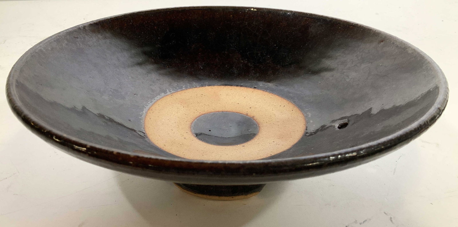 Hand Crafted Glazed Pedestal Pottery Bowl: Bulls eye design, light and dark earth toned glazed, hand crafted, decorative arts, decorative accessory, table ware, measures ht app 3.5 inches diameter 10 inches, collectible art pottery