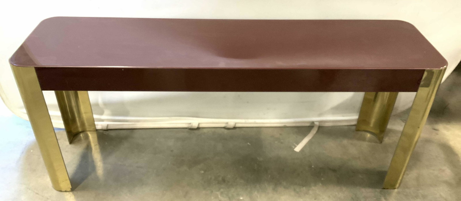 C1970’s Maroon Gold Toned Lacquered Console Table: Sofa table, console table, side board, hall table, retro circa 1970’s high gloss finish, smooth lacquer surfaces, curved semi circular cylindrical legs, rectangular top, sleek lines, measures ht 24 