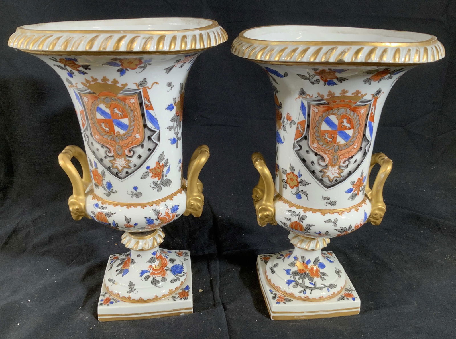 Pair Antique Edme Samson Gilt Porcelain Urns: Pair Antique Samson Of Paris Porcelain Urns, white porcelain with blue and orange Asian inspired floral design, one side Armorial pattern with animal Figurals, pedestal bases with swirl rings, each ha