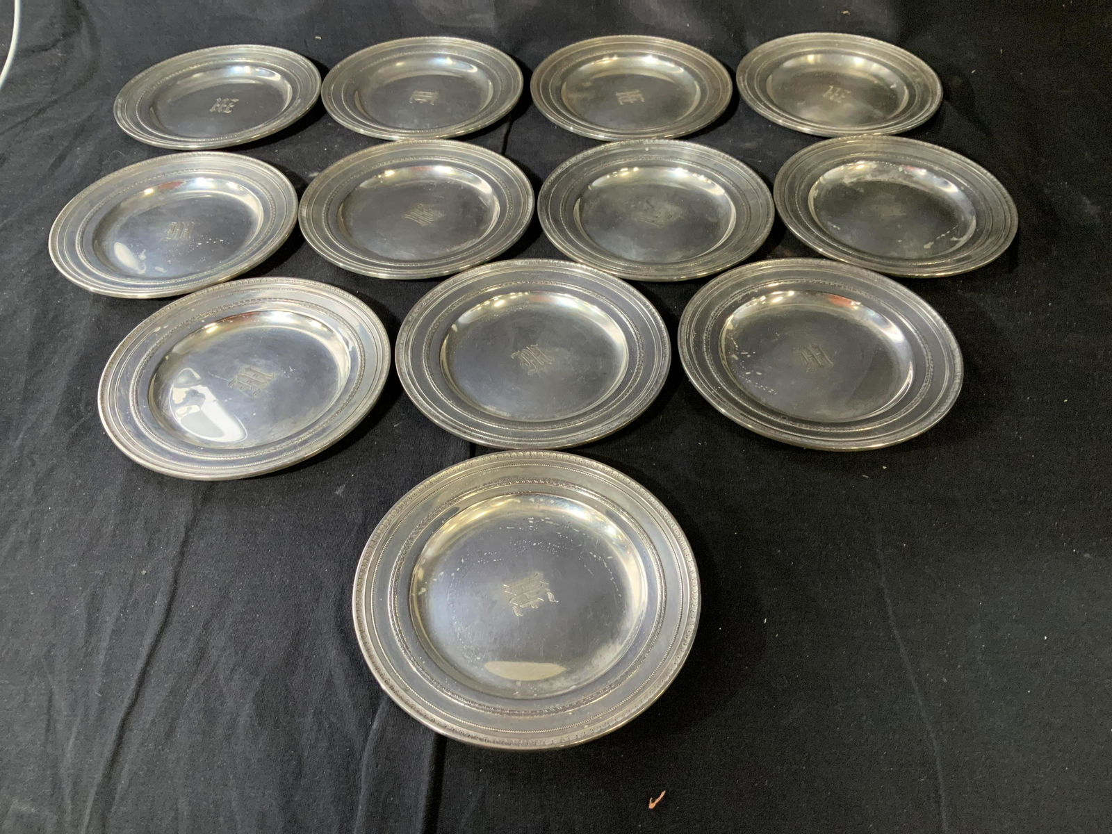 Set 12 Solid Sterling Silver Plates ,49 toz: GORHAM Sterling Silver Plate Set, 48.84 Troy ounces, Diameter of each app 6.25 inches, each has decorative etched chased double borders, center monograms illegible, vintage possibly antique sterling s