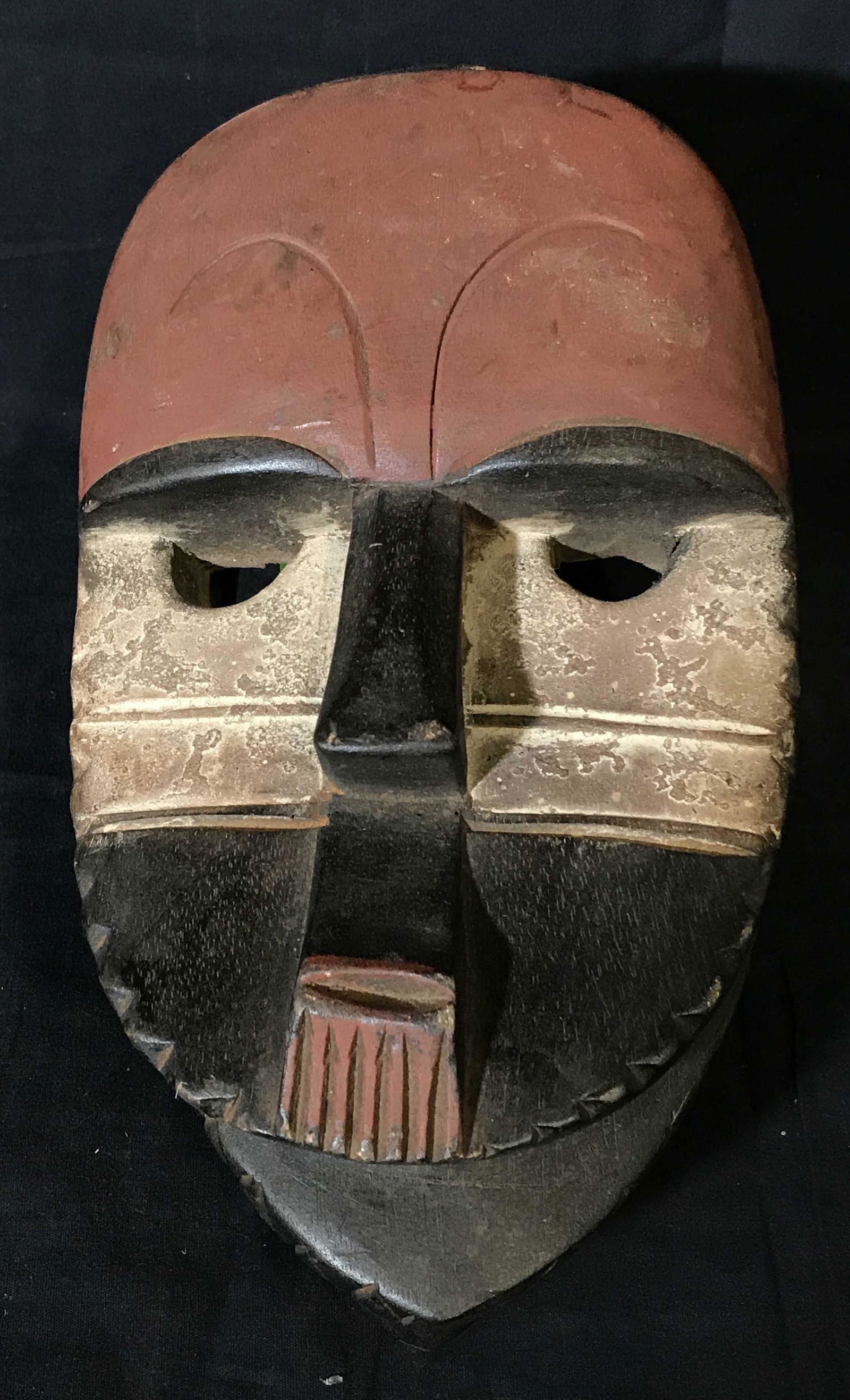 Aduma Gabon Mask: Aduma Gabon Mask, origins can be found in Gabon Central Africa, hand carved from one block of wood, painted with red white and black pigment, Aduma masks are generally characterized by their flats sur