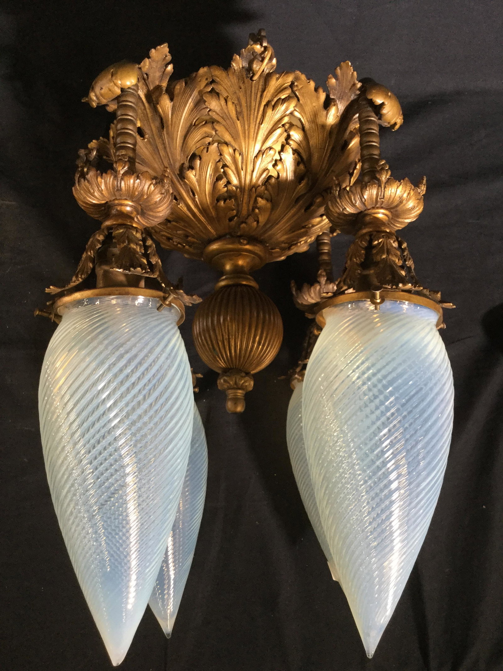 Vintage Bronze Toned Hanging Light Fixture: Light fixture appears to be Bronze Possibly brass. Fixture has 4 bulb sockets and includes 4 attachable glass structures with swirl detail. Fixture has ornate detail. Piece measures approx 12 inches w