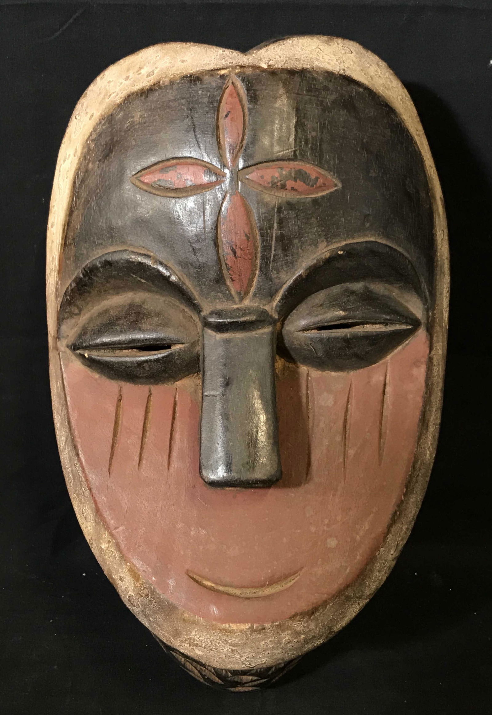 Aduma Gabon Mask: Aduma Gabon Mask, origins can be found in Gabon Central Africa, hand carved from one block of wood, painted with red white and black pigment, Aduma masks are generally characterized by their flats sur
