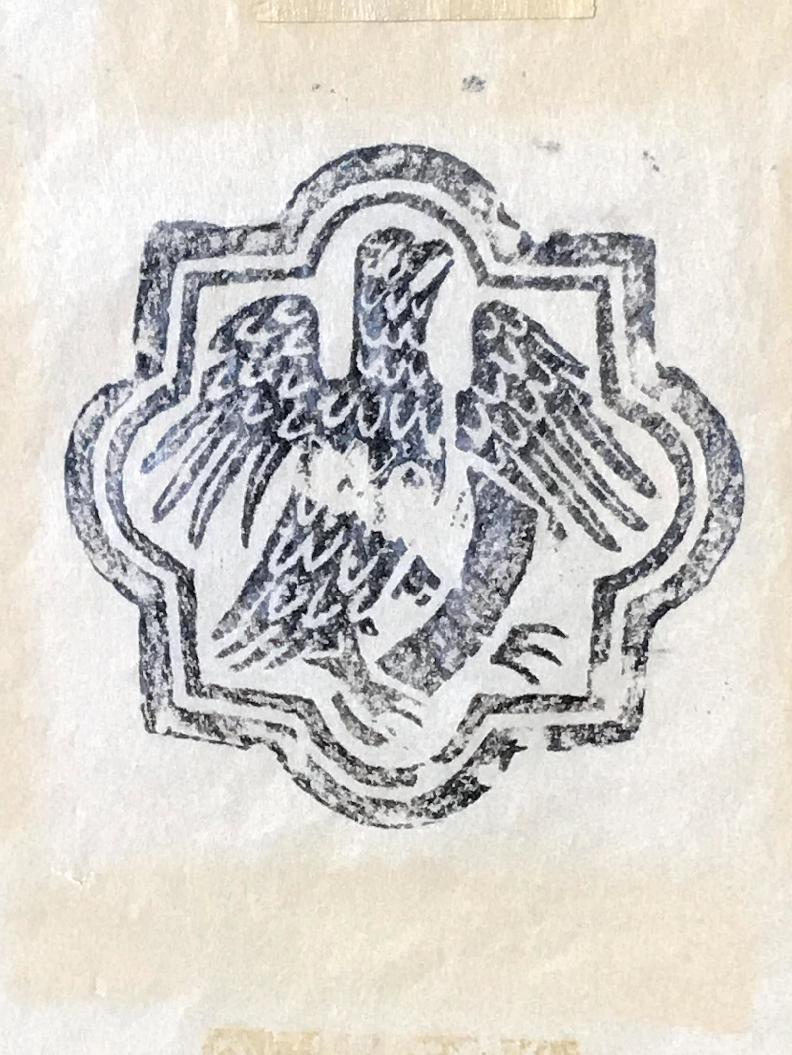 Wood Block Print of Eagle: Woodblock print of Eagle on possibly rice paper, no apparent signature, no frame, tapped to yellow matting, subject a possible insignia with a eagle seated on a branch, measures 7.5 inches tall by 6 i