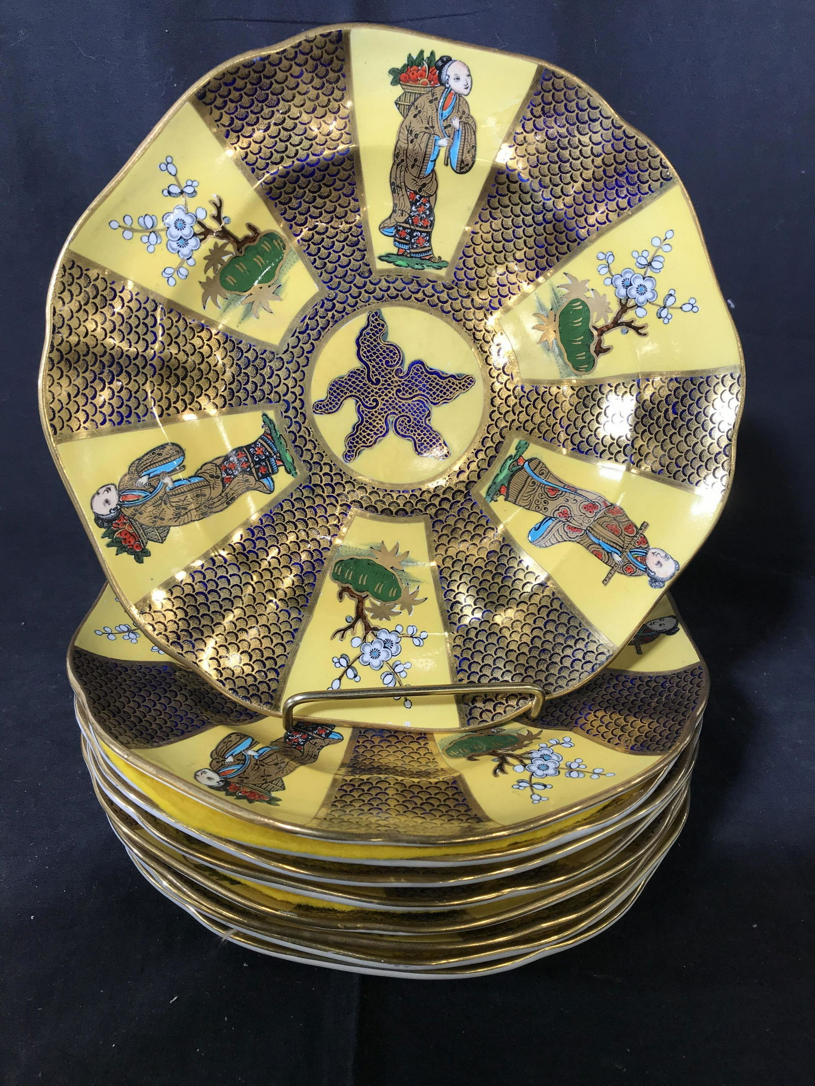 Set 9 Masons Ironstone China, England: Set of 9 porcelain plates, each richly detailed with Asian figurals, garden blossoms on geometric yellow gold and cobalt blue background, vintage place settings, chinoiserie style, orientalism, Orient
