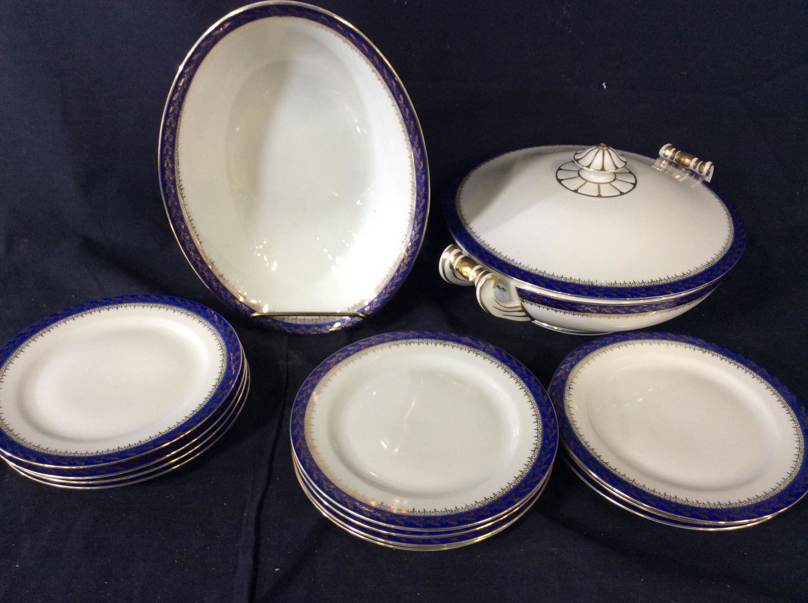 Moritz Zdekauer Vntg Czechoslovakian Server Ware: 13 pcs. 11 dessert plates, 1 covered Tureen with scroll handles (10.5 x 8.5 x 4.5 in.), 1 side dish/ mash potato bowl (9.5 x 6 3/4 in). Green ink stamp under glaze, marked MZ with bird wings spread ou