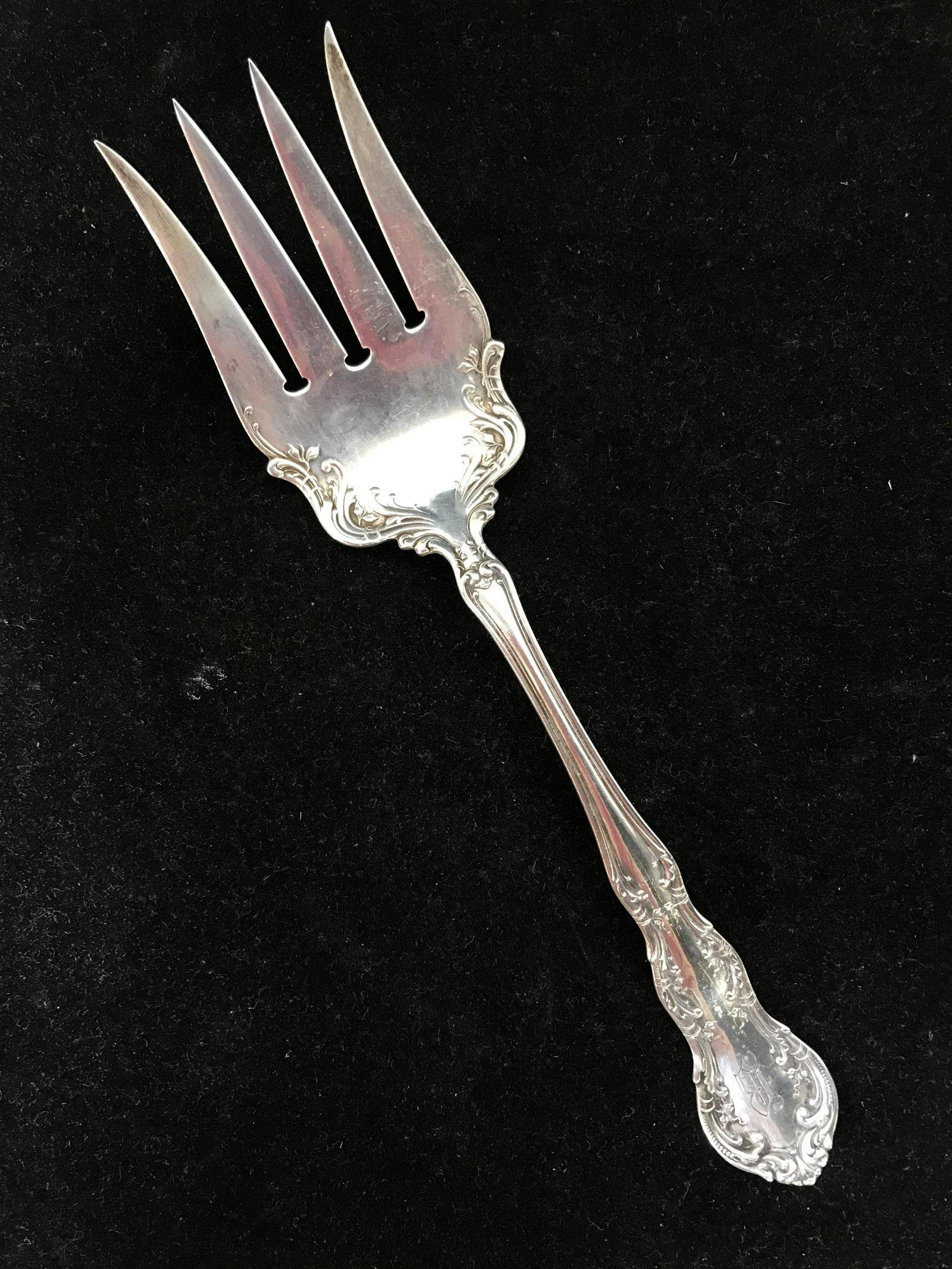 R WALLACE & SONS Sterling silver Serving Fork: Antique Sterling Silver Serving Fork, marked Sterling. R WALLACE & SONS hallmarks are present on the spoon’s underside. The handle is richly detailed, the handle and it’s underside are chased, as 