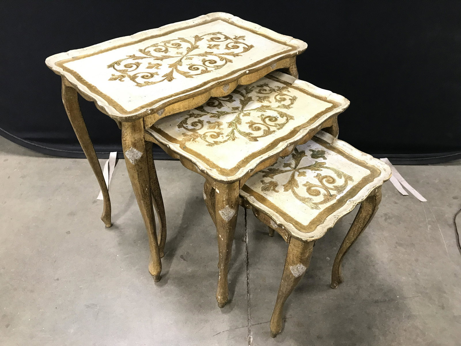 Set 3 FLORENTINE Italian Wooden Nesting Tables: Nesting tables have tag underneath top which reads FLORENTIA MADE IN ITALY. Tables have gold toned ornate detail. Nesting tables are wooden, possibly hand carved. Nesting tables, Italian nesting table