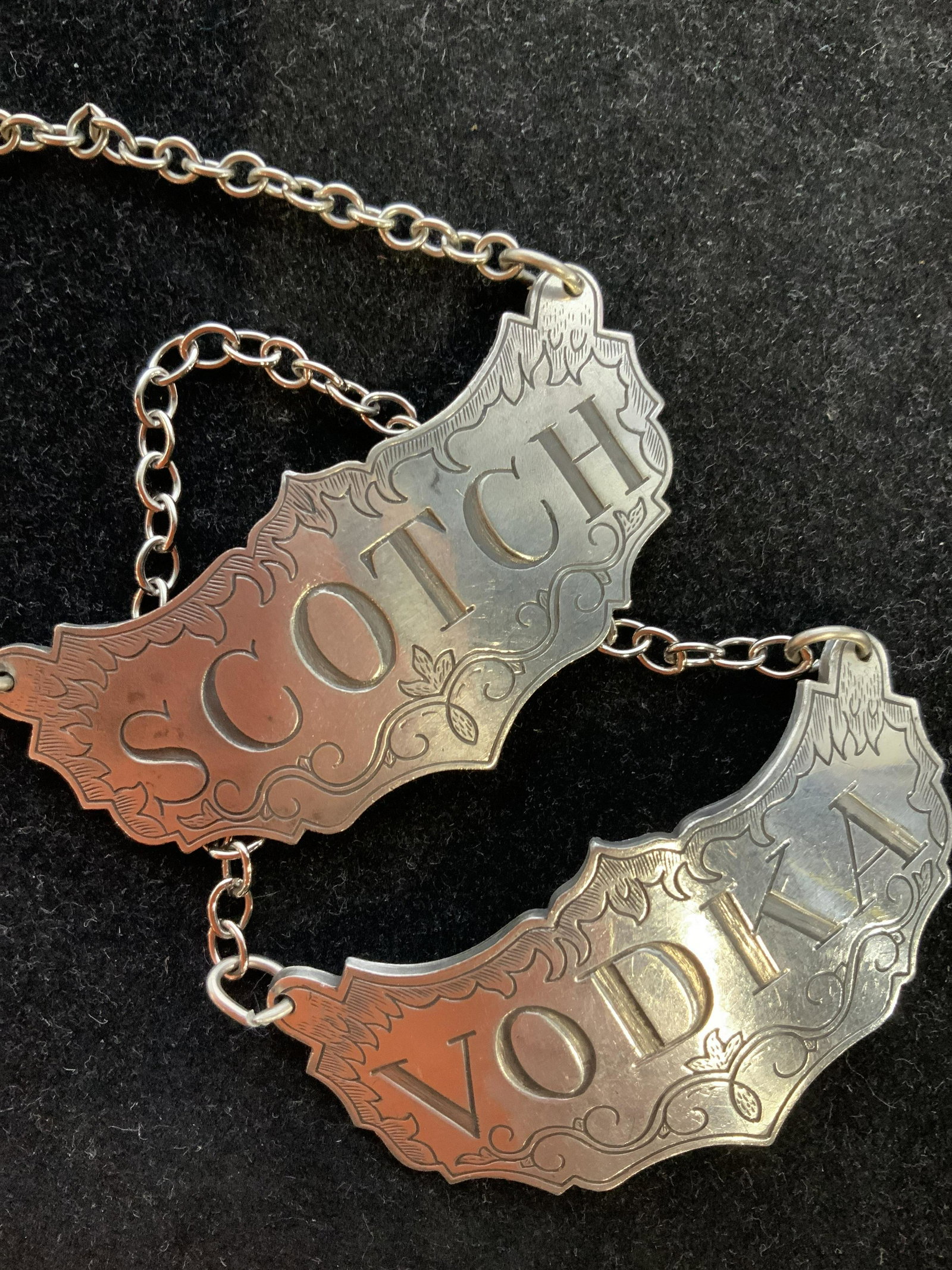 STEIFF pewter Pair of Decanter Necklaces: Each is etched with scrolled edges, marked and trademarked on reverse, one reads scotch, one reads vodka, bar ware, bar accessories, decanter necklaces, each measures 3 by 1.5 inches