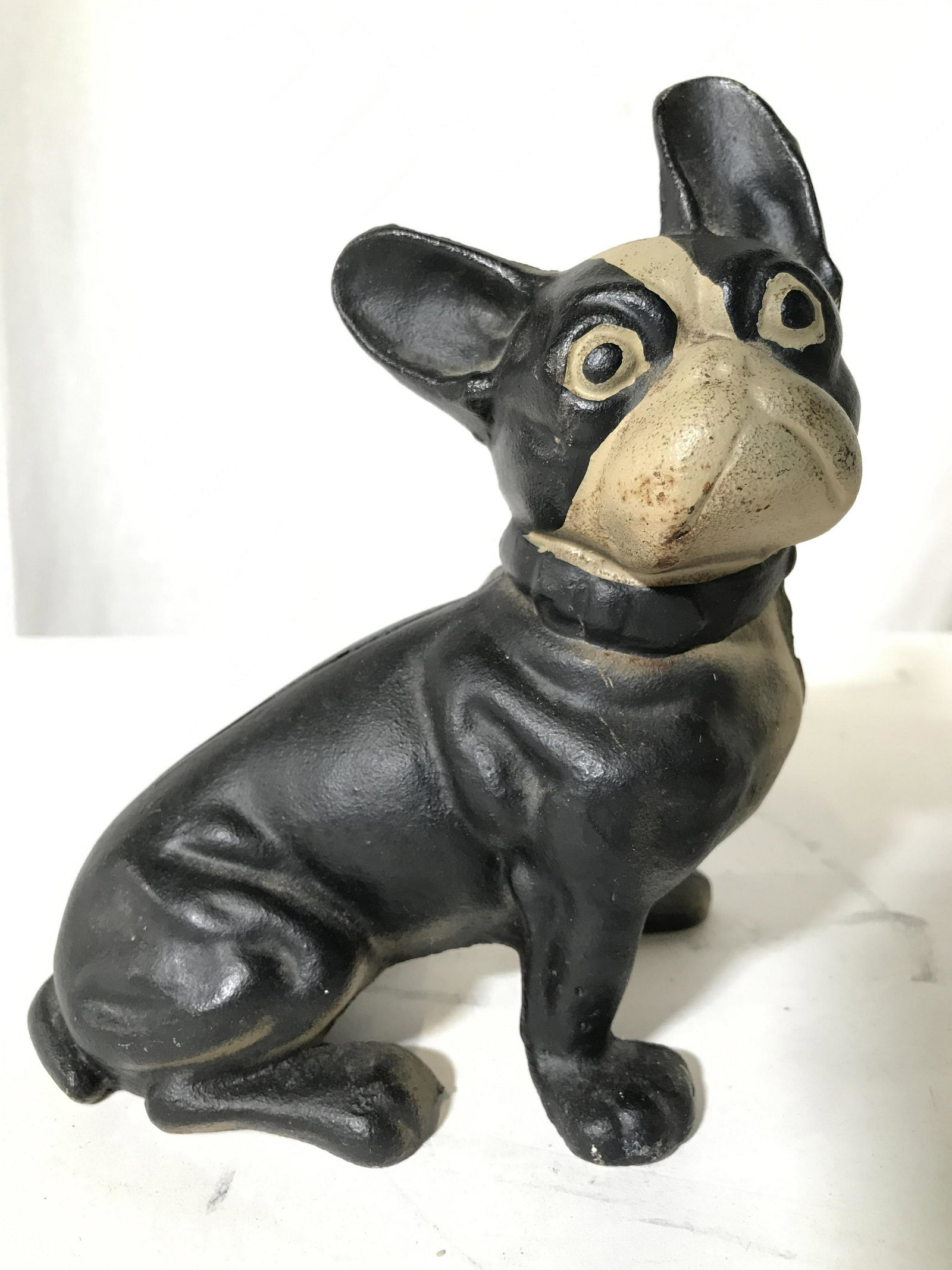 Antique Iron Boston Terrier Door Stopper: Door stopper is iron and antique. Piece is black and slate toned. Iron door stopper, dog door stopper, possibly Boston terrier, possibly French bulldog, possibly pug. Piece measures approximately 7.5 